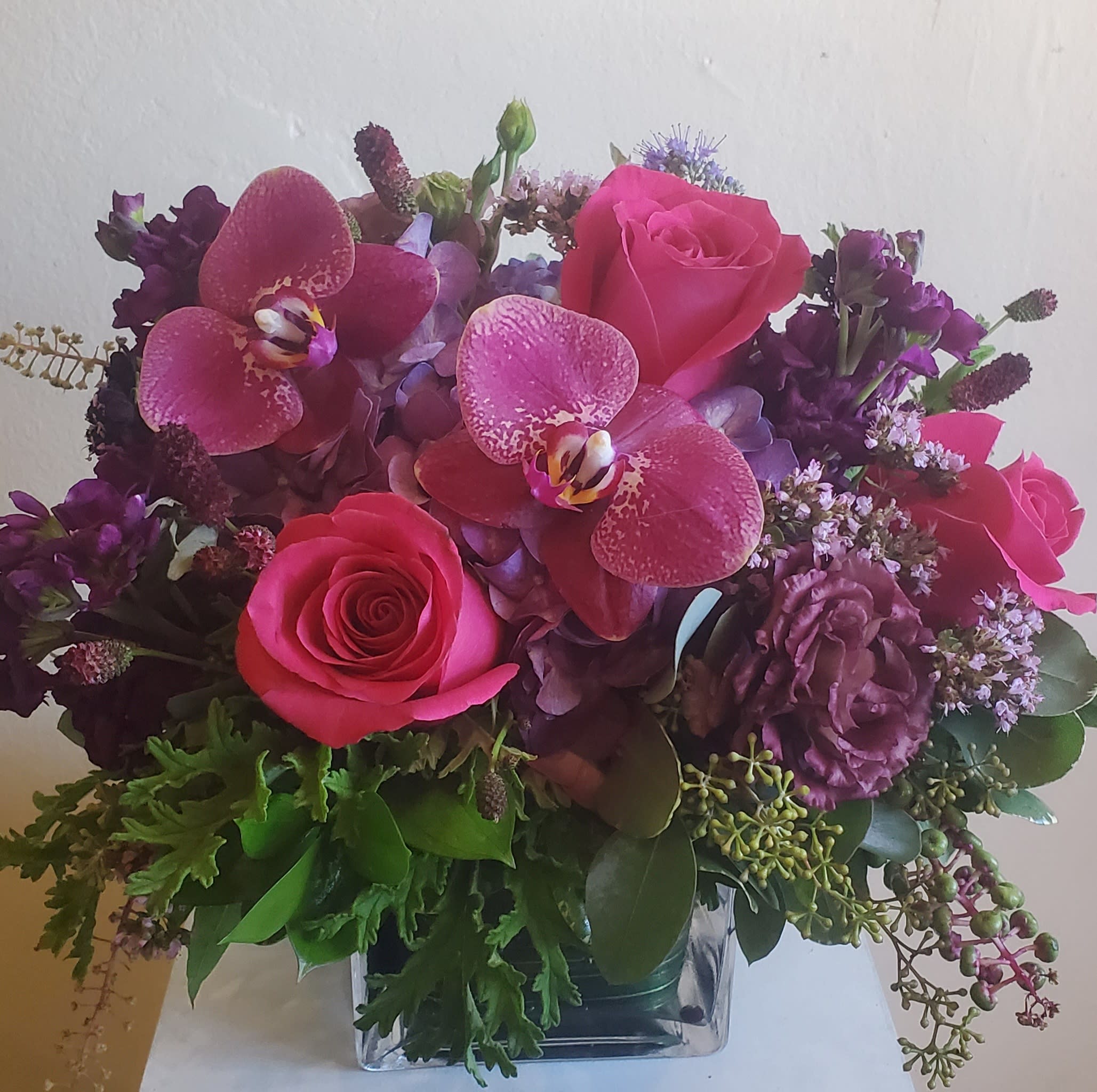 The Del Mar Jewels - Arranged with rich jewel tones. Purple, plum and hot pink flowers, such as Hydrangea, lisianthus, roses, stock and orchids or equivalent dependent on availability. 