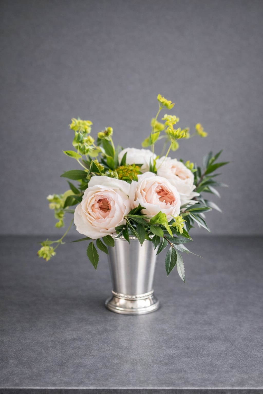 Blush Garden  - A petite arrangement of luxurious garden roses, complemented by airy green bupleurum and fresh greenery. A delicate, garden-inspired design perfect for adding refined charm to any moment.  Approximately 8-10 inches tall, 7-8 inches wide.