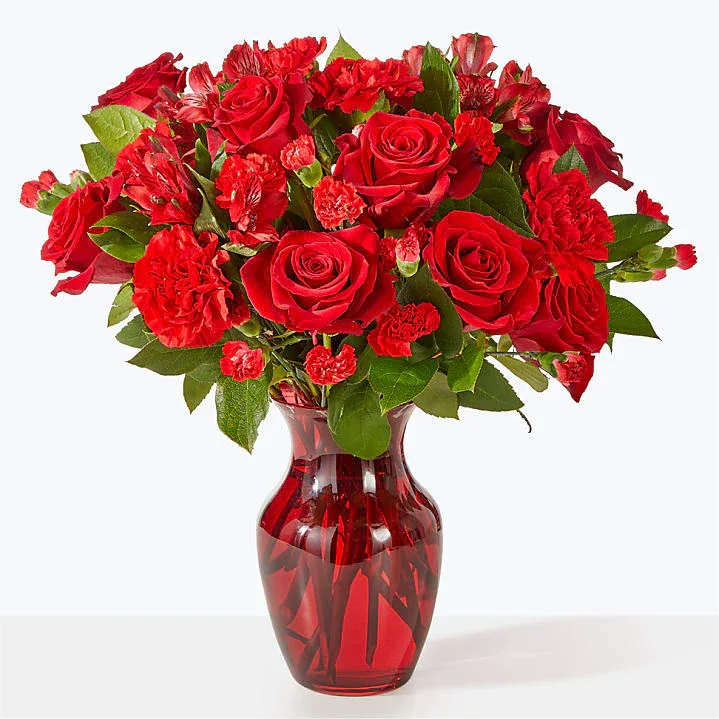 Love Conquers All - Red roses with red carnations. Show her timeless love. 