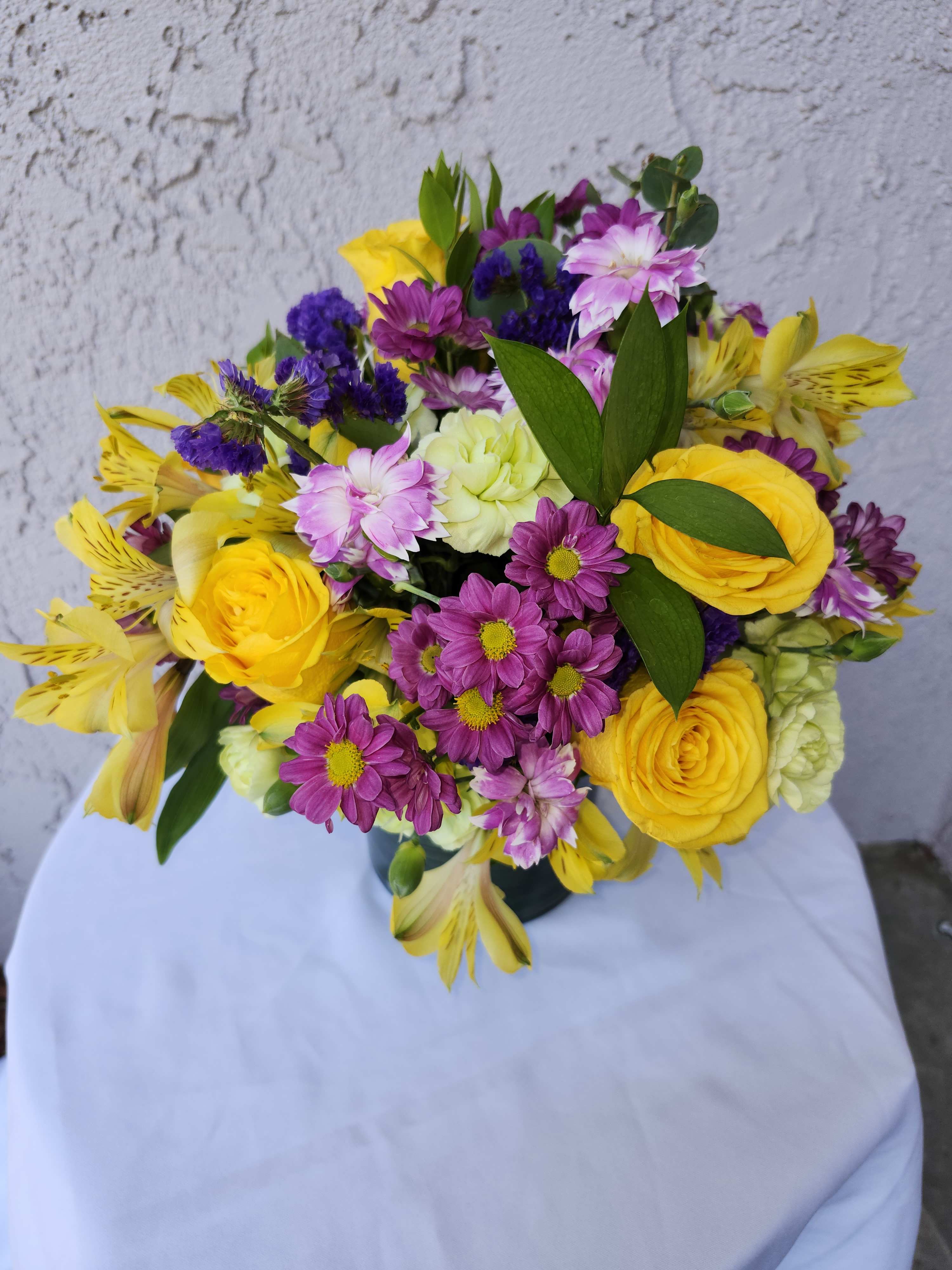 Solomino Bloom - Vibrant purples and yellows bouquet of roses, alstermeria, daisies, carnations for summer smiles.