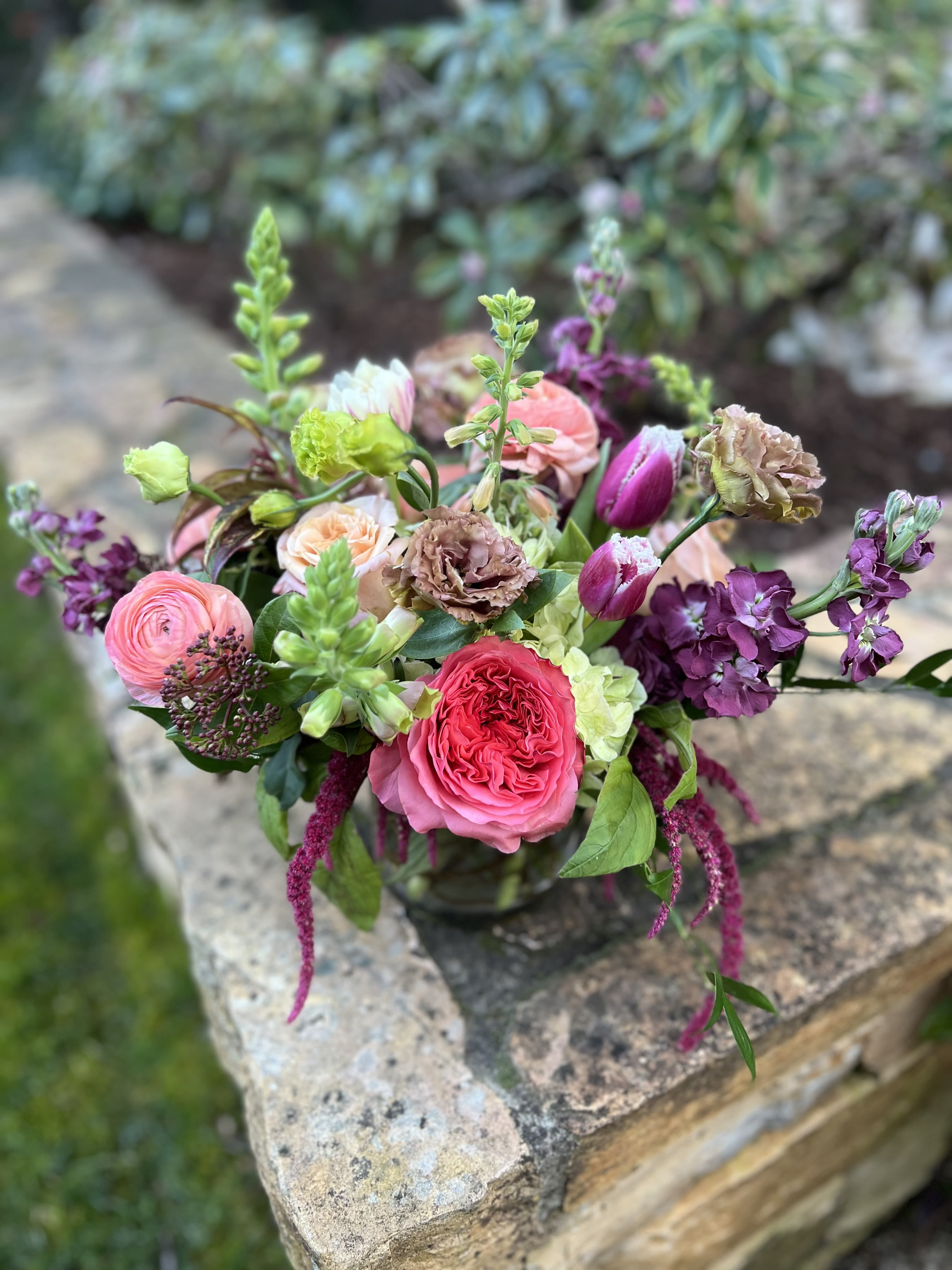 Meet Me in the Garden - Coral garden roses, green hydrangea, moody stock and tulips, hanging amaranth and peach ranunculus make up this garden inspired beauty! 