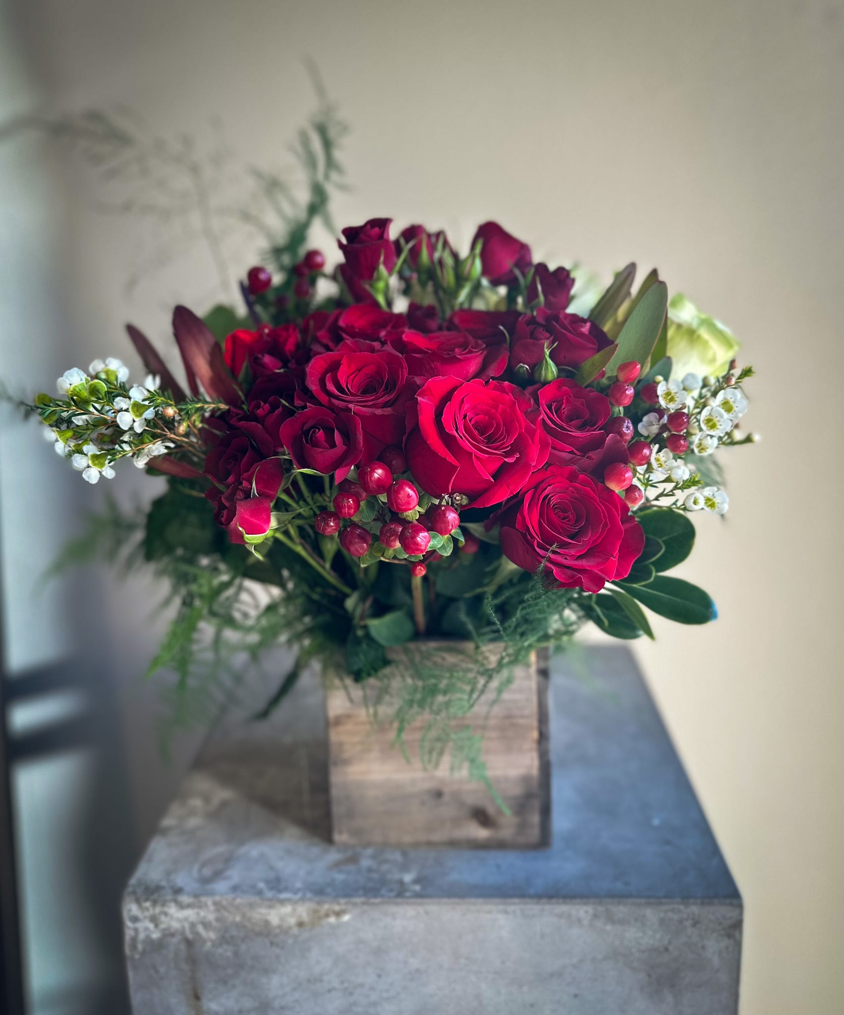 Love and Happiness - Enjoy the vibrant beauty of red and classic white roses, complemented by red spray roses, purple wax flowers, and more. This stunning arrangement is presented in an off-white woodland vase, perfect for adding charm and elegance to any space. Order now for quick and reliable delivery!
