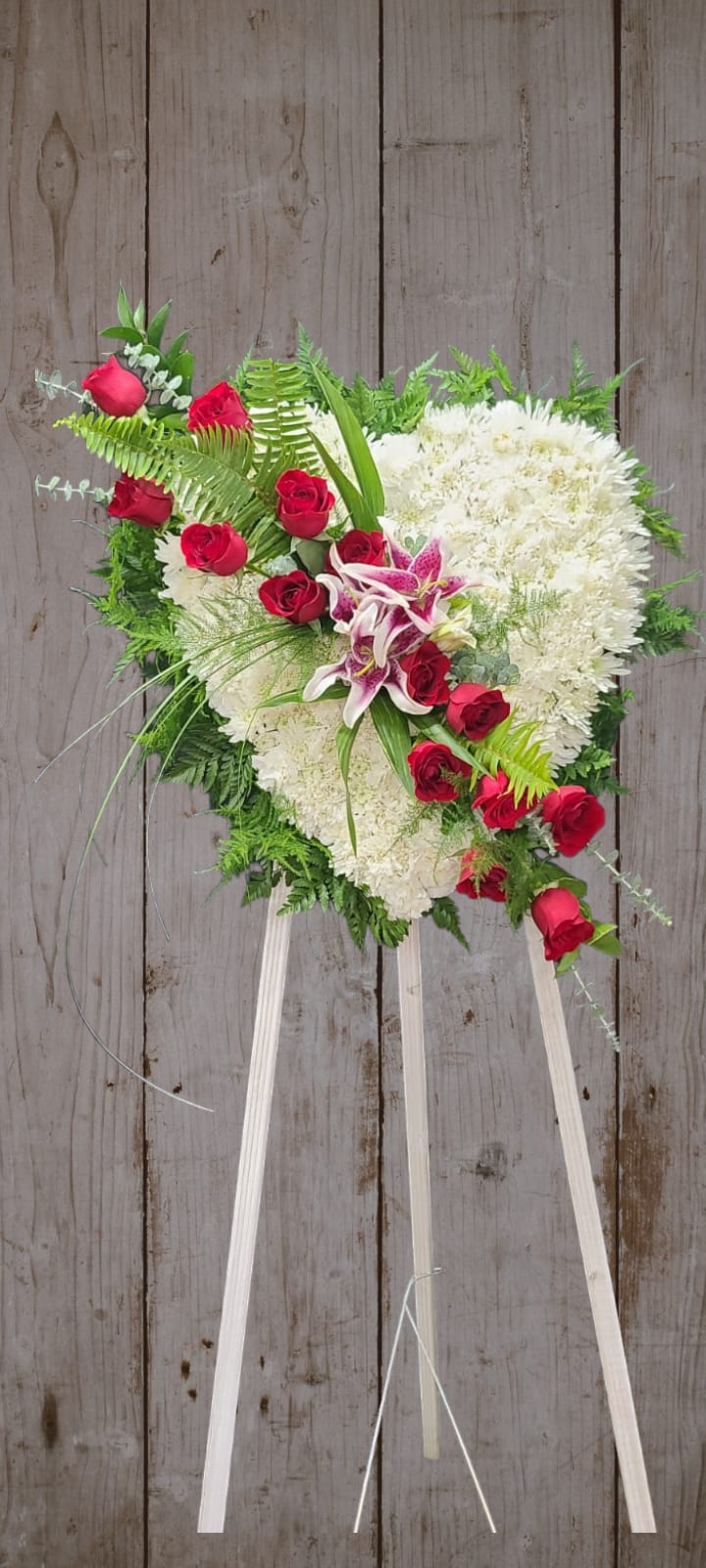 Broken Hearted - The loss of a loved one often shatters our hearts. This beautiful standing spray expresses your deepest grief and sympathy. Roses, Lilies and Chrysanthemums. 