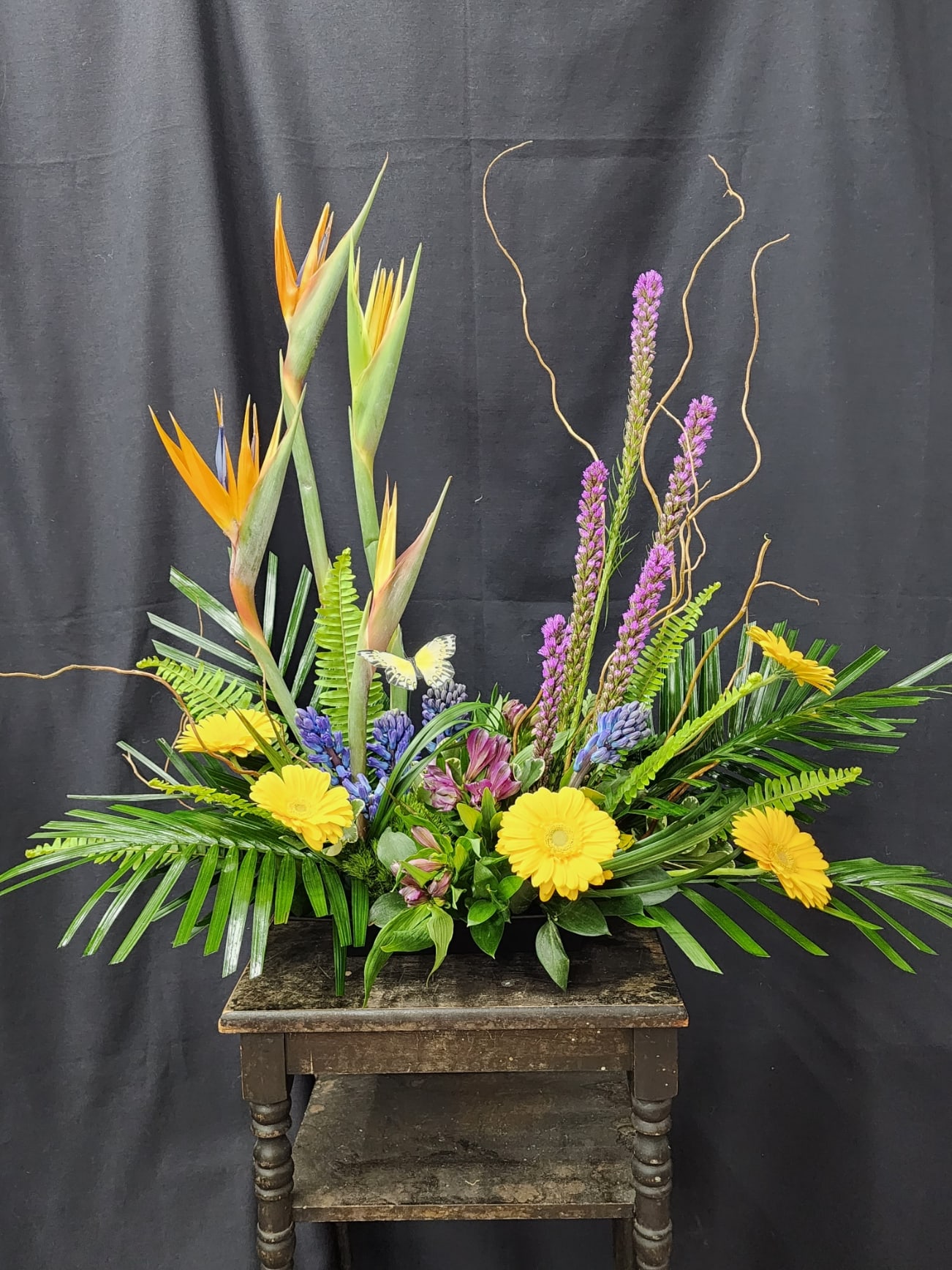 Forever Remembered. - This tropical delight is sure to wow and leave a lasting impression. Birds of Paradise, Gerbera Daisies, and Liatris create a stunning visual display. A wonderful arrangement for the service or the home.
