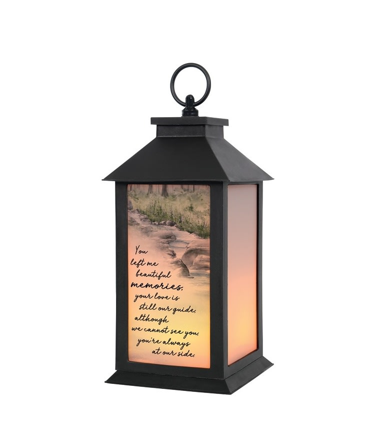 "Beautiful Memories" Lantern - This lantern reads "You left me beautiful memories, your love is still our guide, although we cannot see you, you're always at our side." These lanterns are made of weather friendly materials and UV printed glass. They are 12" tall and include a flameless LED candle with a built-in automatic timer: 6hrs ON/18hrs OFF. It can be purchased individually or with an accompanying floral arrangement (Deluxe).  