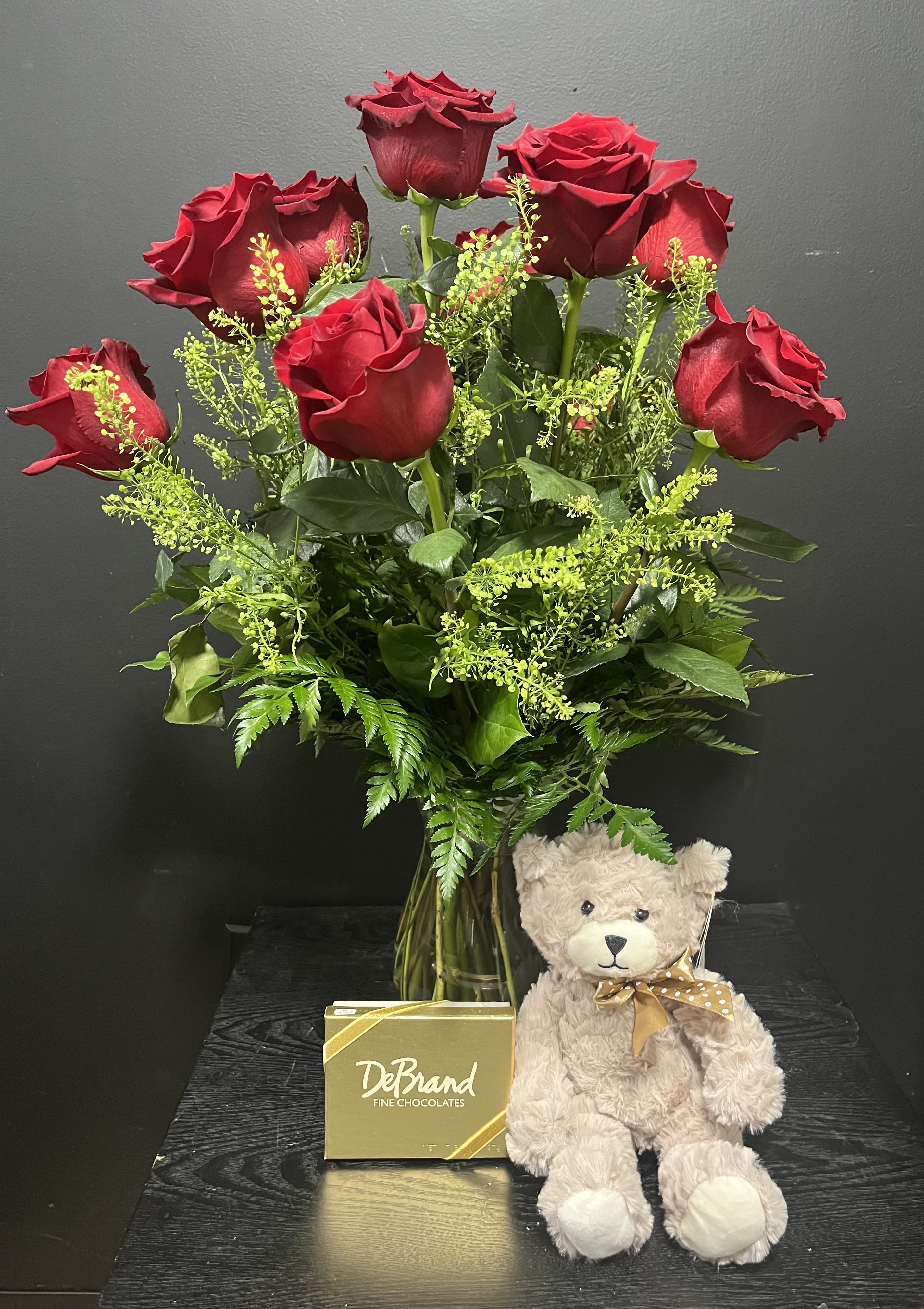The Classic Bundle - Dozen Red Roses with a Teddy Bear and an assorted box of DeBrands Fine chocolates 