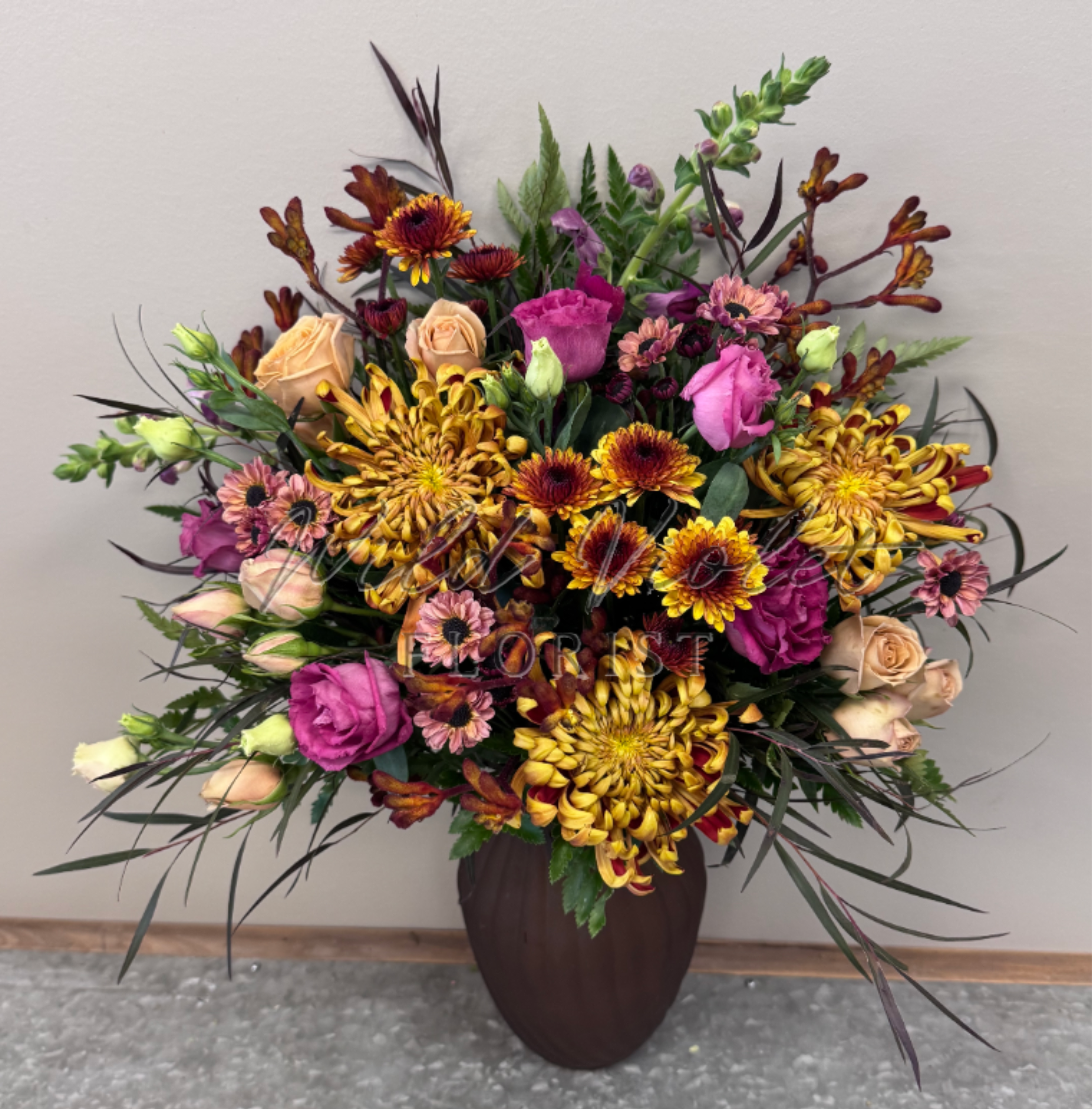 November Topaz Bouquet - Birthstone Collection What better way to celebrate your loved one's birthday than with our November Topaz Bouquet! Hand-designed with a gorgeous gathering of amber blooms, unique kangaroo paws &amp; soft taupe spray roses and striking fuchsia touches, it’s a thoughtful sentiment filled with the warmth, comforting beauty of a topaz stone.  ATTENTION! If you are ordering this arrangement on a different month other than what it's respected month is, there will be substitutions for certain flowers depending on seasonal availability. We will stay within the same color scheme and design style!  PLEASE NOTE: Florist reserves the right to make modifications to the design based on seasonality and accessibility of blooms and vases. Any modifications made will honor the palette, intent, and feeling of the pictured design. Contact floral designer directly with any specifications or concerns.