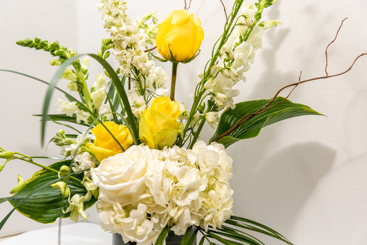 Simply Delightful - This stunning collection of yellow roses and white blooms will brighten anybody's day. Send this sympathy arrangement as a tribute to a loved one’s sunny disposition or to uplift a mourner's spirits. Whatever the occasion, it's a splendid option to reassure somebody that brighter days lay ahead.