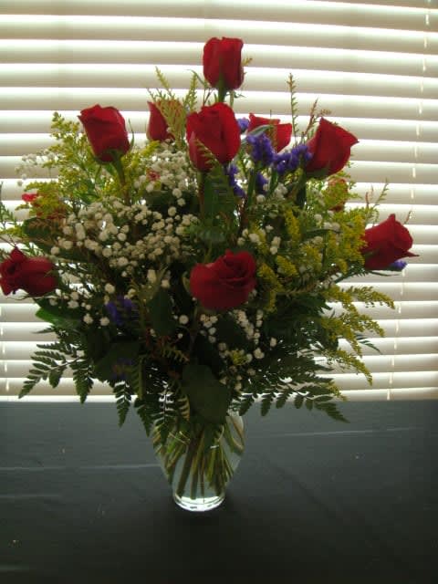 Radical Roses - A Dozen Red Roses Upgraded With Fancy Filler Flowers. Filler flowers Will Vary Depending On Season.
