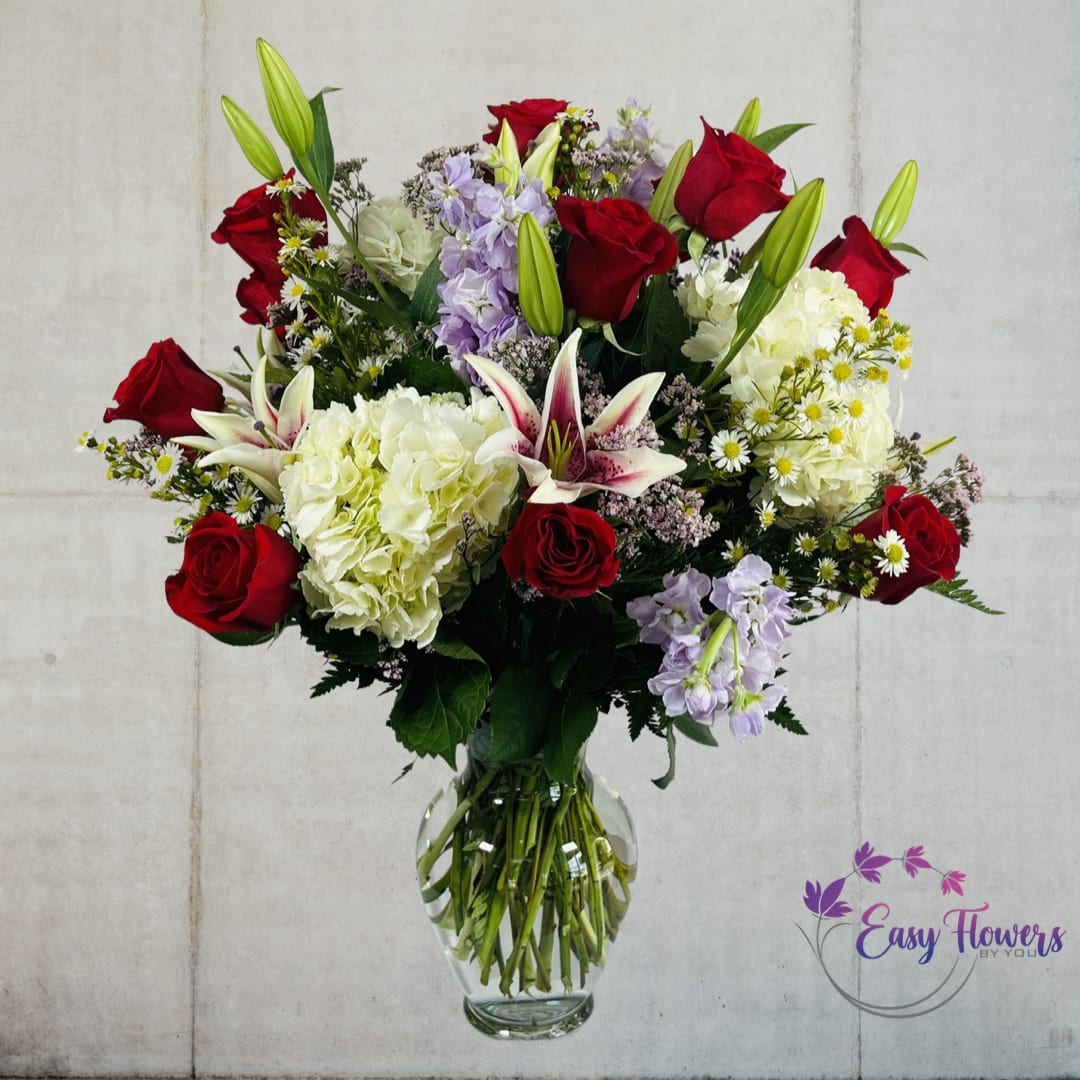 Troy - Make any occasion special with our stunning floral arrangement of vibrant red roses, exquisite oriental lilies, and gorgeous hydrangeas elegantly arranged in a clear glass vase with lush greens and filler. This lovely combination is sure to captivate and impress your loved ones.