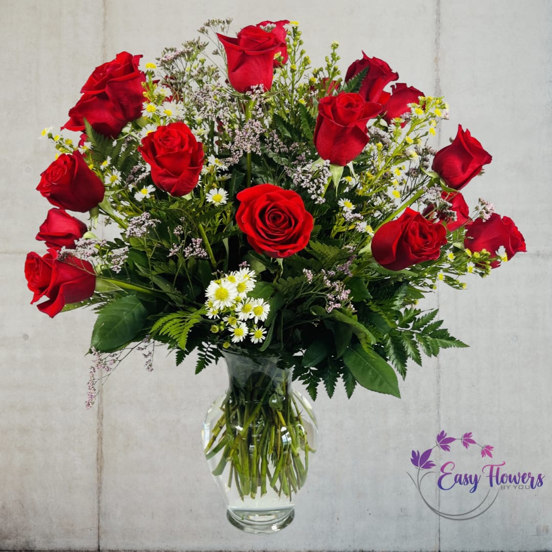 Two Dozen Premium Long Stem Red Roses - Experience the power of love with our premium long-stemmed rich red roses, expertly arranged in an elegant clear glass pedestal vase. Our 24-inch roses are sure to make your heart skip a beat and create a dazzling display of beauty that will bind your hearts together as one. This timeless tradition will connect your past and future in a way that is unforgettable.