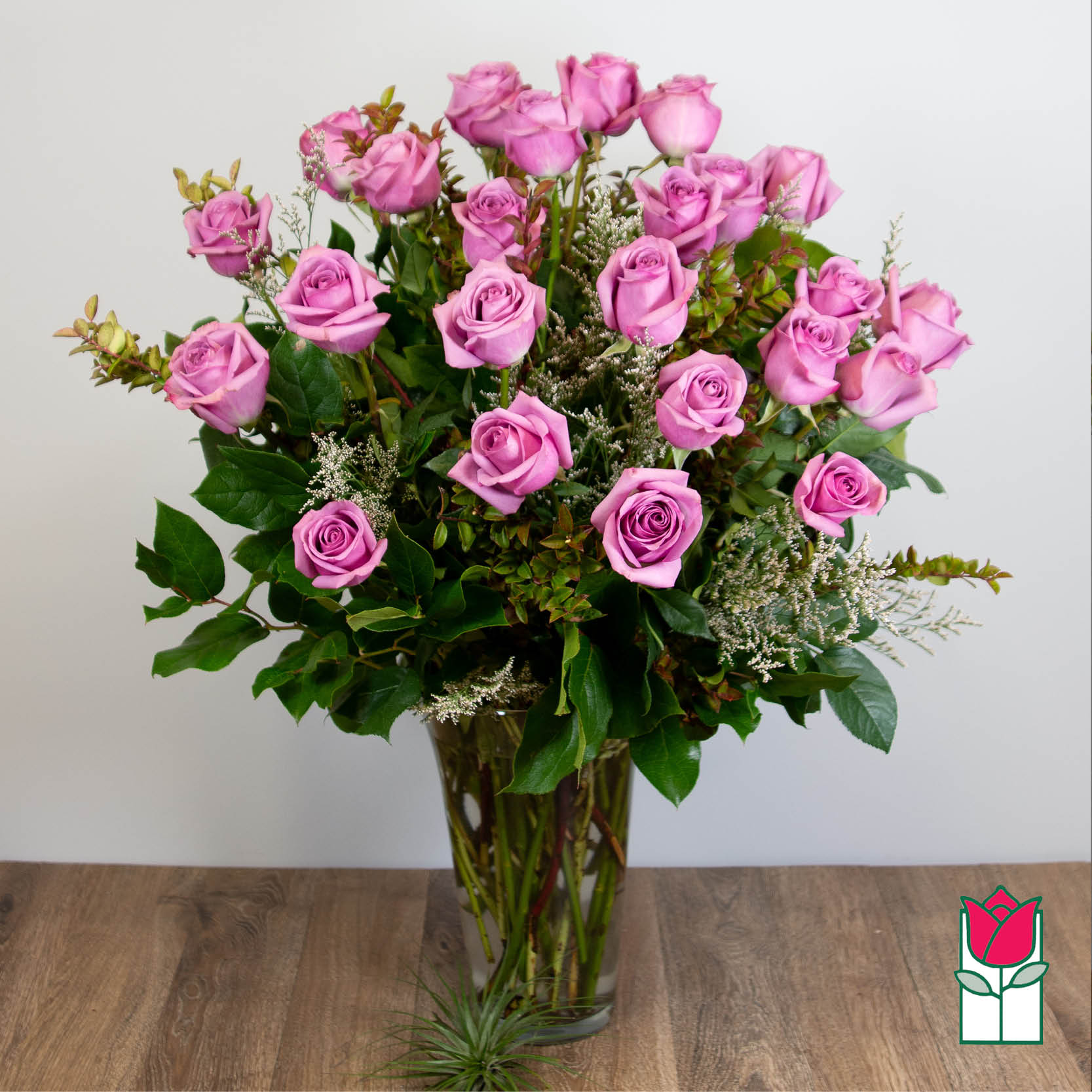 Beretania's 2 Doz. Extra Long Stem Lavender Rose Bouquet [Lavender Hue Varies] - 2 Dozen Premium Extra Long Stem Lavender Roses  Indulge in the timeless elegance of the Beretania Florist Premium Extra Long Stem Roses bouquet. Our exquisite bouquet features premium Ecuadorian extra-fancy roses, which are 30% larger than any other rose in the islands. Available in a classic glass vase with assorted foliage and filler flowers, this bouquet is the perfect gift for any occasion.  But our exceptional product is only half the story. At Beretania Florist, we pride ourselves on our professional and convenient delivery service. We carefully hand-deliver each bouquet to ensure it arrives at its destination in pristine condition. Our team is dedicated to providing the highest level of customer service, and we strive to exceed your expectations with every order.  And for added convenience, we offer the option to choose or upgrade the number of roses in your bouquet. Whether you prefer a classic one dozen, a stunning one and a half dozen, a grand two dozen, or an opulent three dozen, we have the perfect bouquet for you.  Trust Beretania Florist to deliver the highest quality roses and the best service in the Honolulu area.