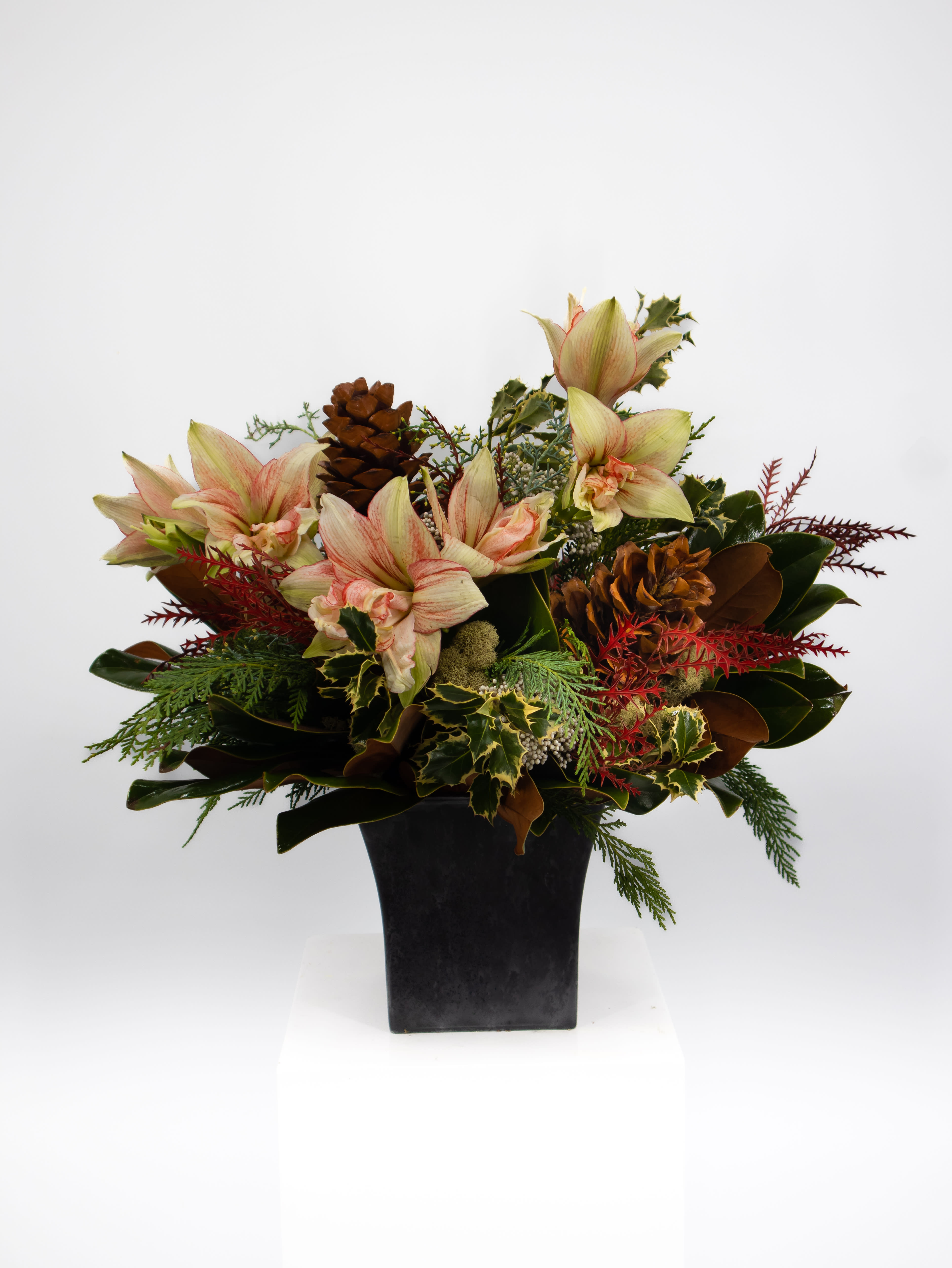 Adrian - This stunning arrangement brings together the delicate and more natural look seamlessly. Full of lush greens and sharp looking florals topped off with a few rough natural elements. This piece will be sure to grab everyones eye who see's it.