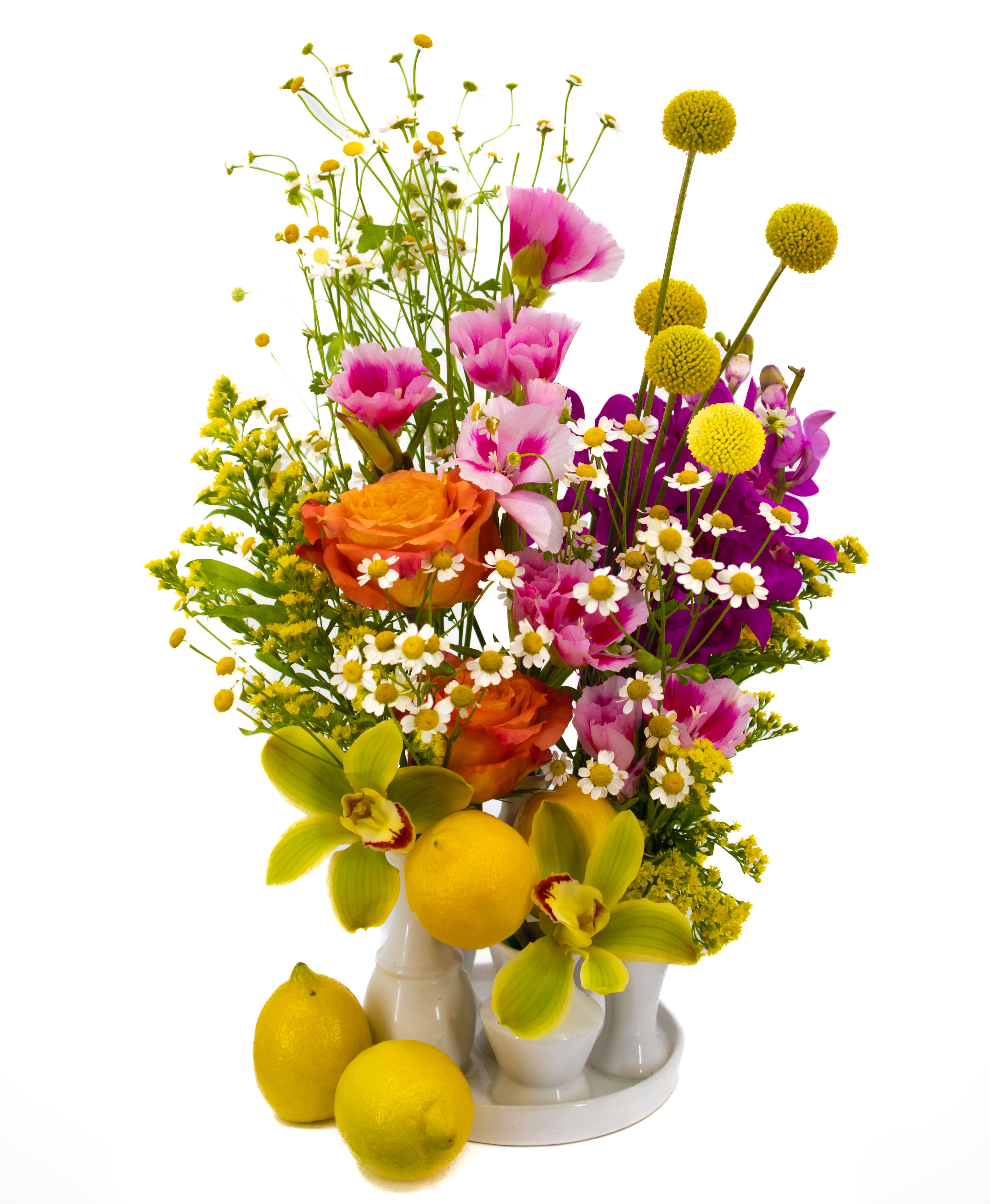 Chris - A lovely pop of color for any space is achieved with this new arrangement. The unique vase will hold clusters of some of the most classic flowers we all love. The chamomile brings it all together with a fun and fresh take for a bouquet.