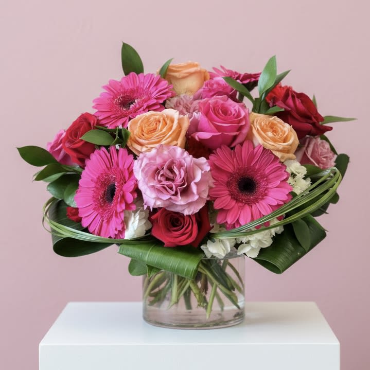 Electric Love - VALENTINE'S DAY COLLECTION | LOCAL DELIVERY ONLY  Celebrate love with a vibrant Valentine's Day arrangement bursting with colorful roses, hydrangea, gerbera daisies, and carnations. Designed in a clear cylinder vase, "Electric Love" is perfect for someone who loves color and a modern twist on design. Flowers &amp; colors may vary, making each bouquet a unique expression of love.