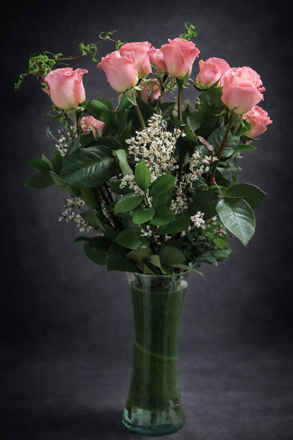 Dozen pink roses - One dozen pink roses arranged in a tall clear vase.
