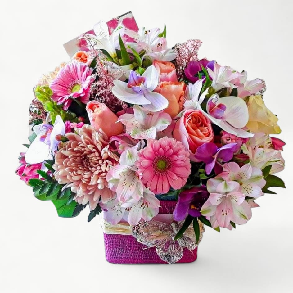 Pink Spectacular Bouquet Designer's Choice - Roses orchids hydrangeas and so much more arranged in a modern glass cube vase wrapped in pretty pink jute ribbon adorned with a lovely butterfly. Beautiful and perfect to send today to show them how much you care. All of my bouquets are always made extra special and unique each time. Send them happiness. Send them beautiful.