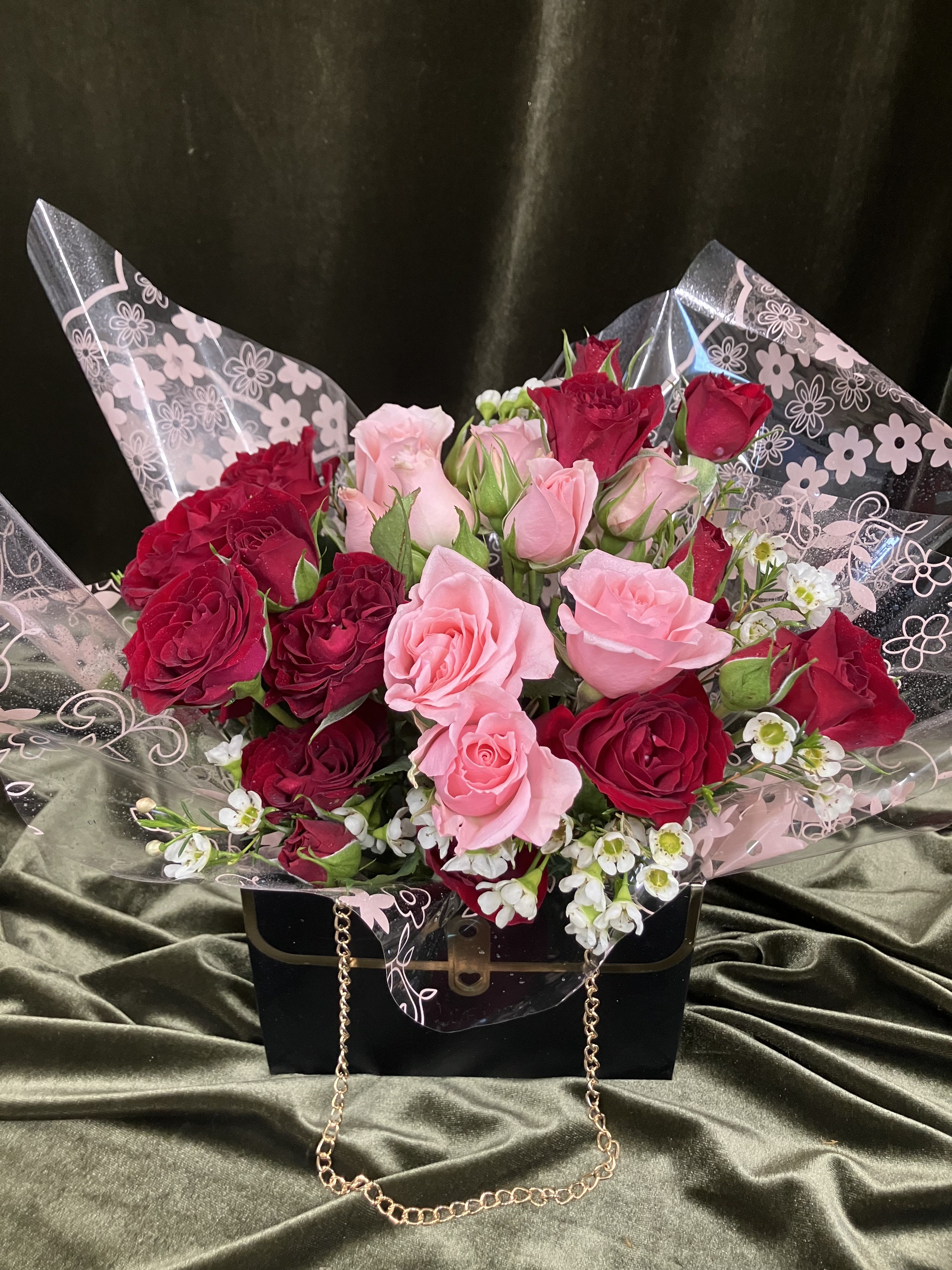 Cute Purse Arrangement  - Perfect gift for the girl that loves glam, fashion and bags. A cute little black handbag box with gold chain handles, mini roses, and filler flower 