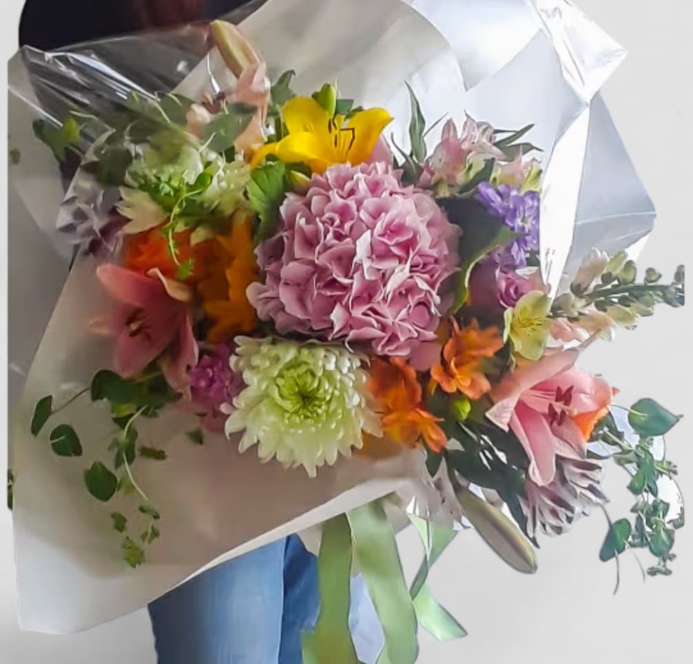 Beautiful Presentation Bouquet Beauty Designer's Choice - Perfect for every occasion. Send this beauty today to show them how much you care with it's beautiful mixed blossoms of that day roses orchids and more wrapped in pretty white paper and ribbon. Please visit my beautiful gallery to see my latest designs that I have created for my online customers. Send them a special bouquet to make them smile today.