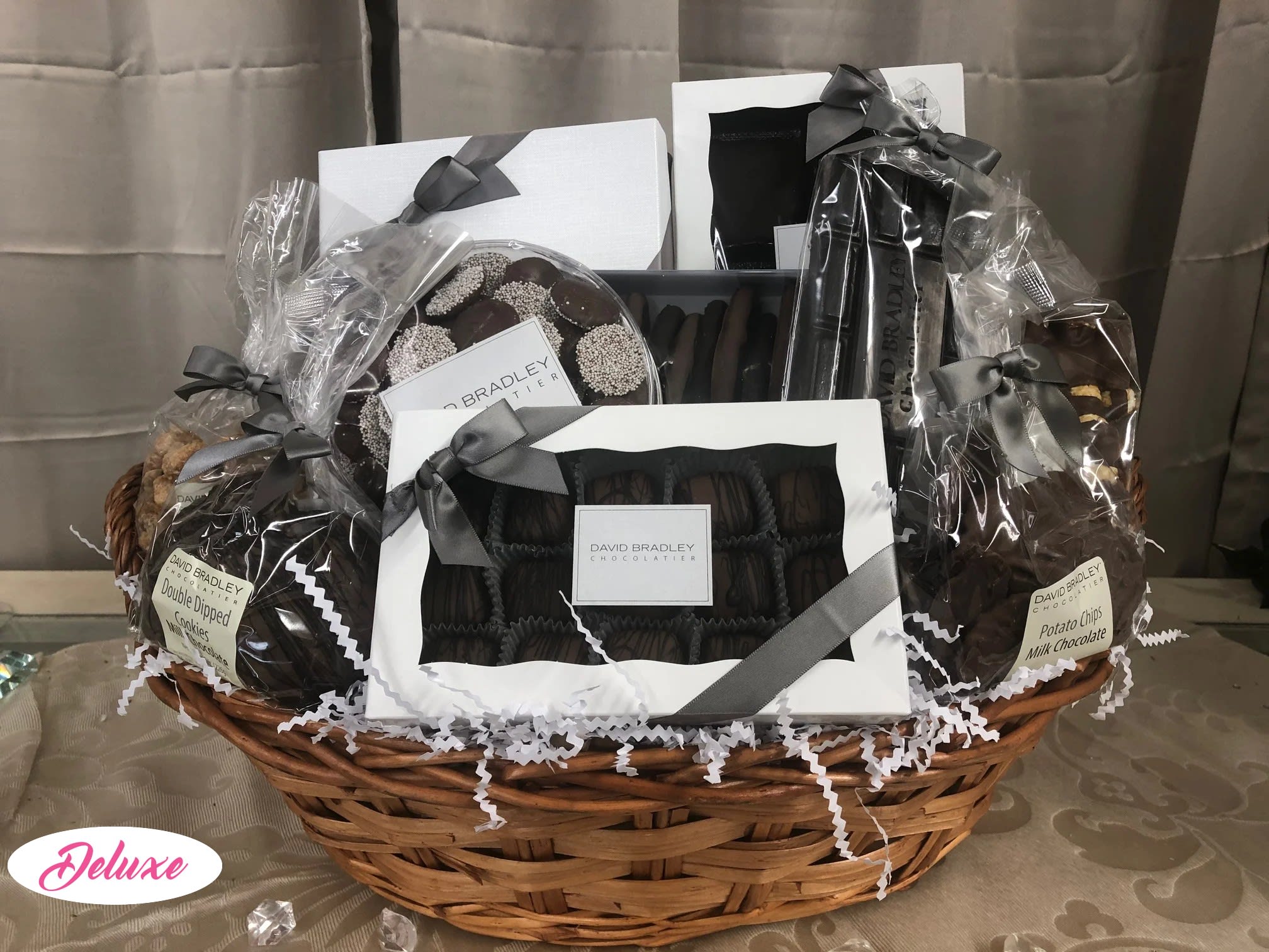 David Bradley Executive Basket *LOCAL DELIVERY ONLY* - David Bradley has a beautiful, delicious assorted basket of chocolates. A mixture of both milk and dark chocolate sure to please anyone that receives it.  *LOCAL DELIVERY ONLY* 