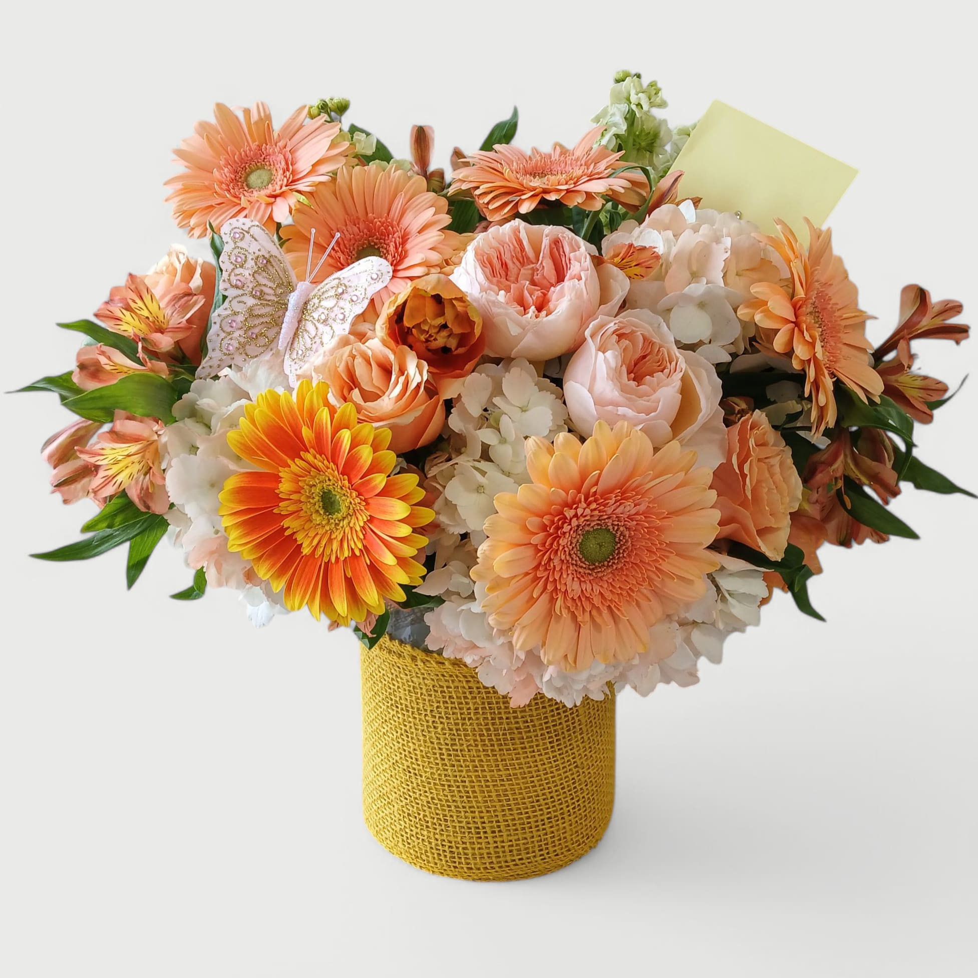 Happiest Of Birthdays Peach Rose Bouquet - Send this beautiful all peach bouquet filled with roses hydrangeas daisies and more arranged in a tall modern glass vase wrapped in cheerful pretty yellow jute ribbon. This is perfect to send for wishing them the very happiest of birthdays. 