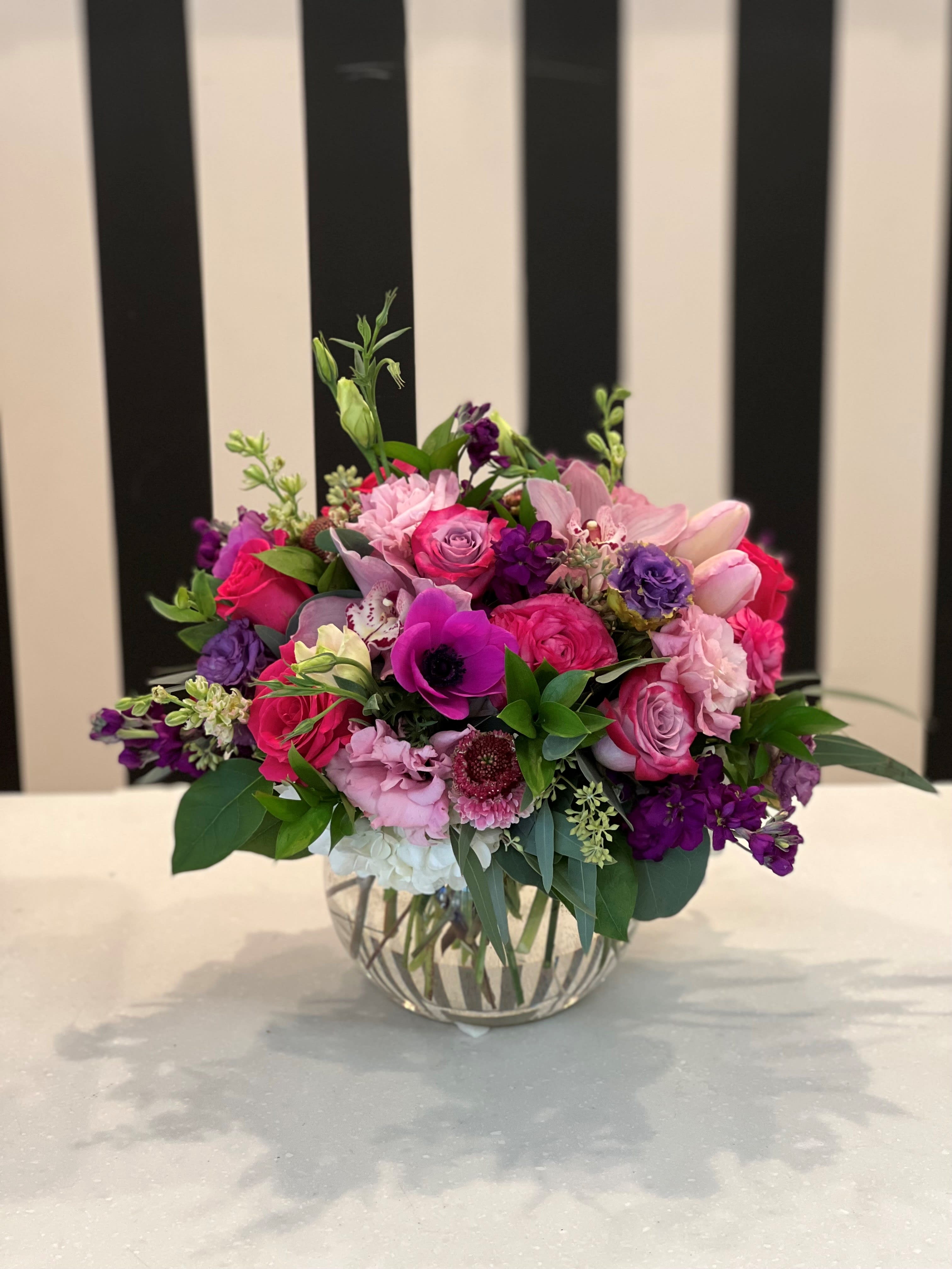 Daydream Bubble Bowl - A variety of pink and purple flowers fill our beautiful bubble bowl with eucalyptus and mixed greenery. Romantic Bouquets Santa Clarita Roses delivery Santa Clarita, Same-day delivery Santa Clarita, Local Florist in Santa Clarita, Valencia, Stevenson Ranch, Newhall, Saugus, and Canyon Country