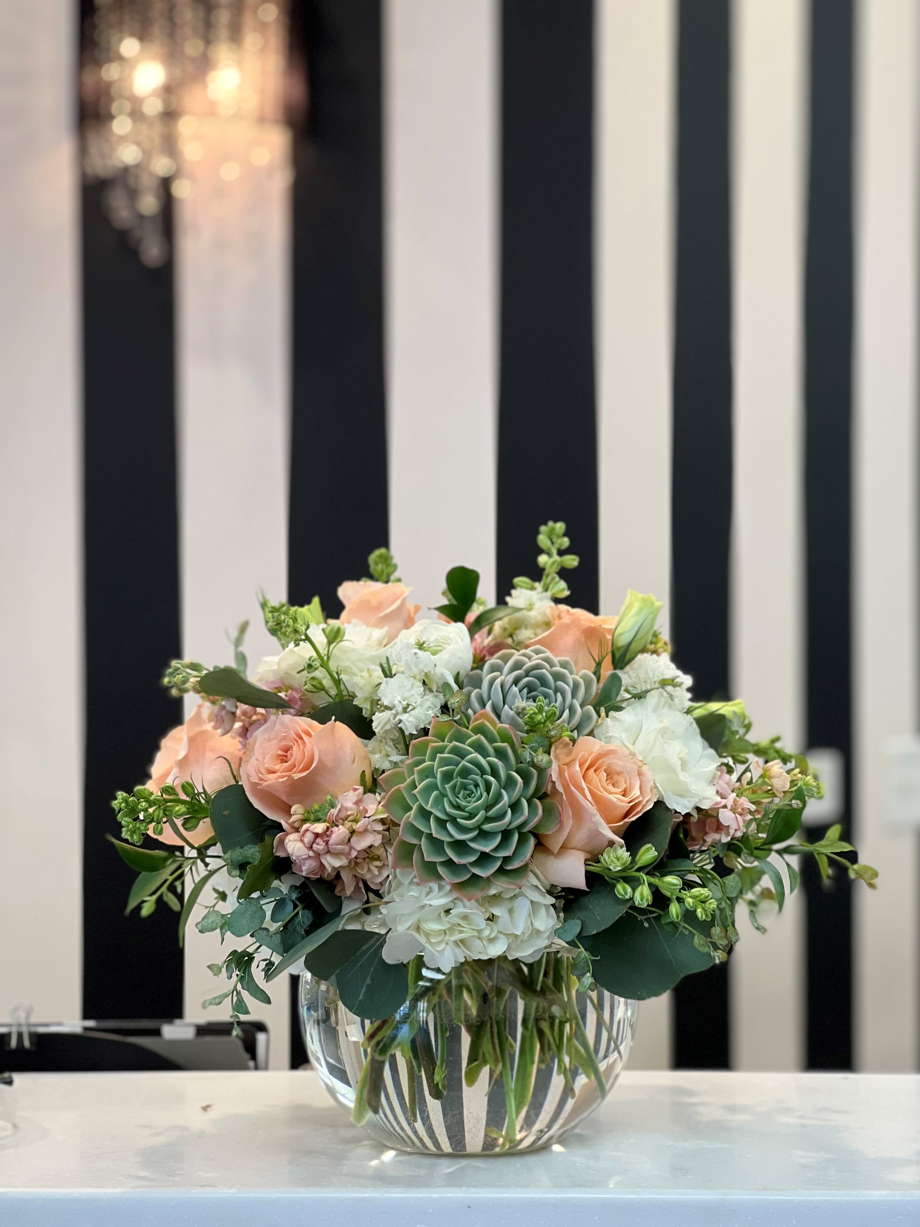 Peach Desert - Peach roses and stock, with white flowers compliment the beautiful succulents in this arrangement.