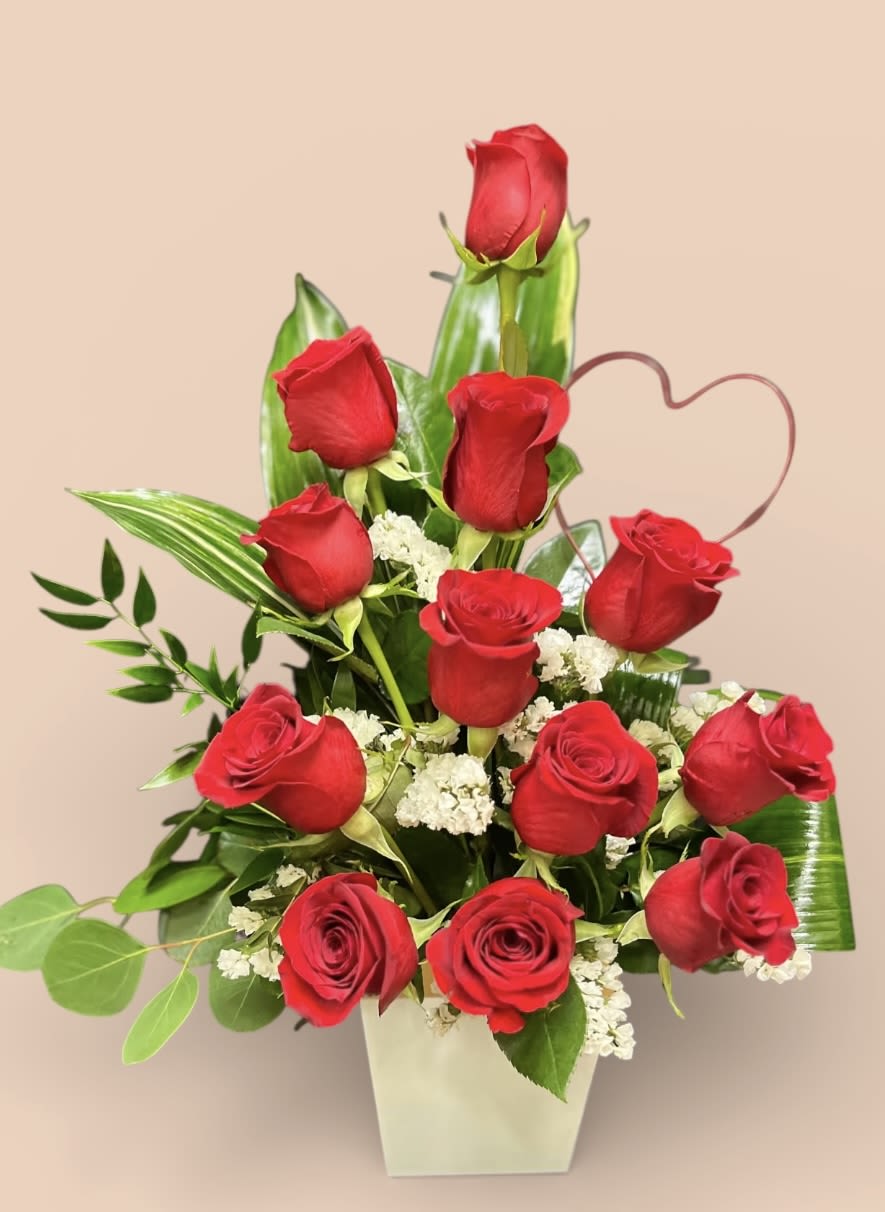 Rose's with a twist - Nothing says love more than a unique dozen red roses designed in a resin cube. Container may vary.