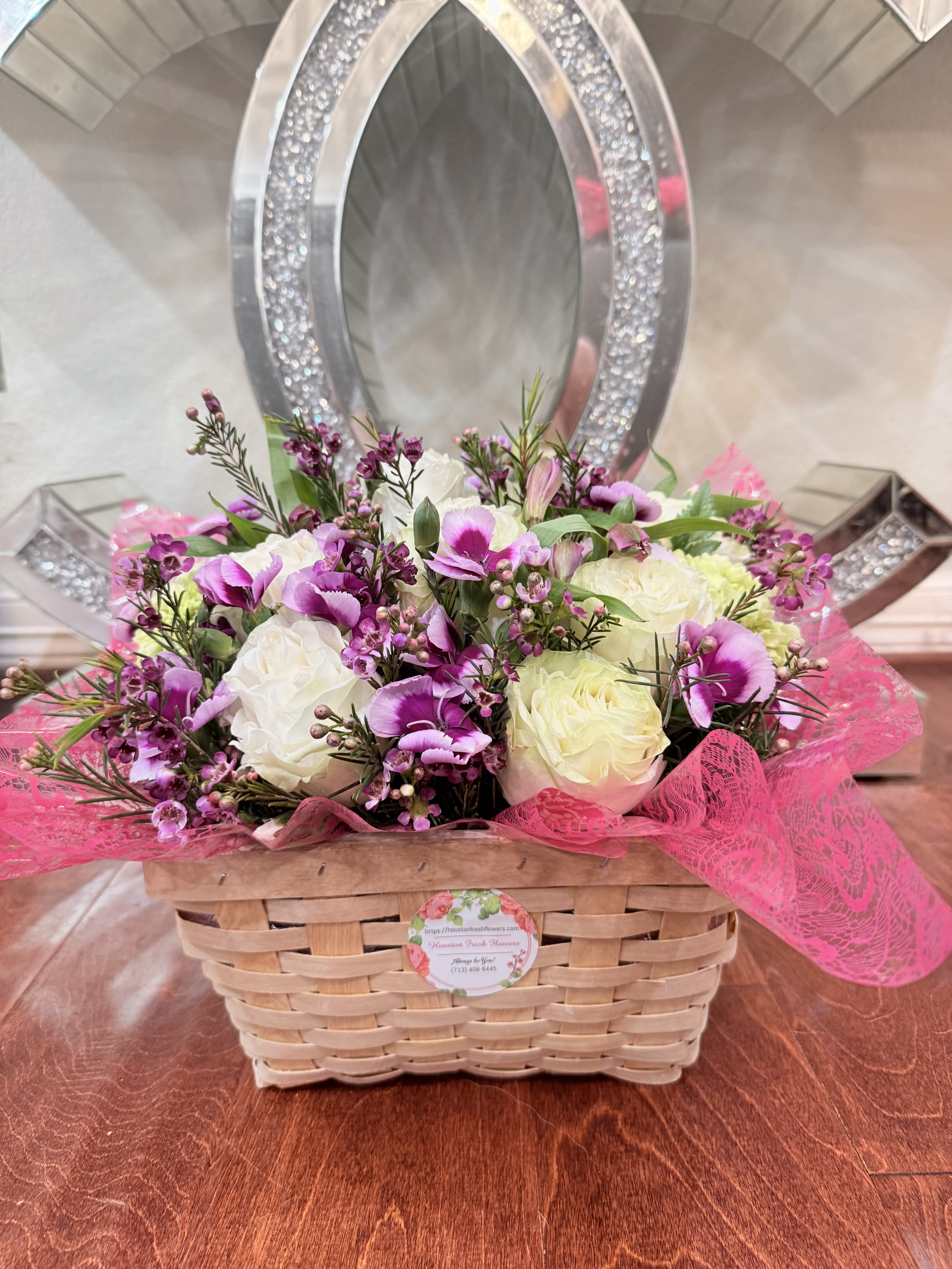 Basket of Joy-Designer choice  - When the breeze is warm and the flowers are blooming send Basket of Joy. Cream roses and tulips with accent purple freesia make this spring in a wicker basket! Perfect for Easter, Passover, Mother's Day, New Baby and as any spring party centerpiece. Please Note: The basket can be changed.