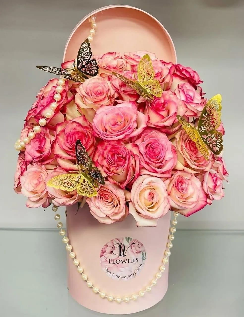 Cute Pink Roses in a Box - A pink box filled with pink roses. Decorated with pearls and gold butterflies. Call us to make adjustments.