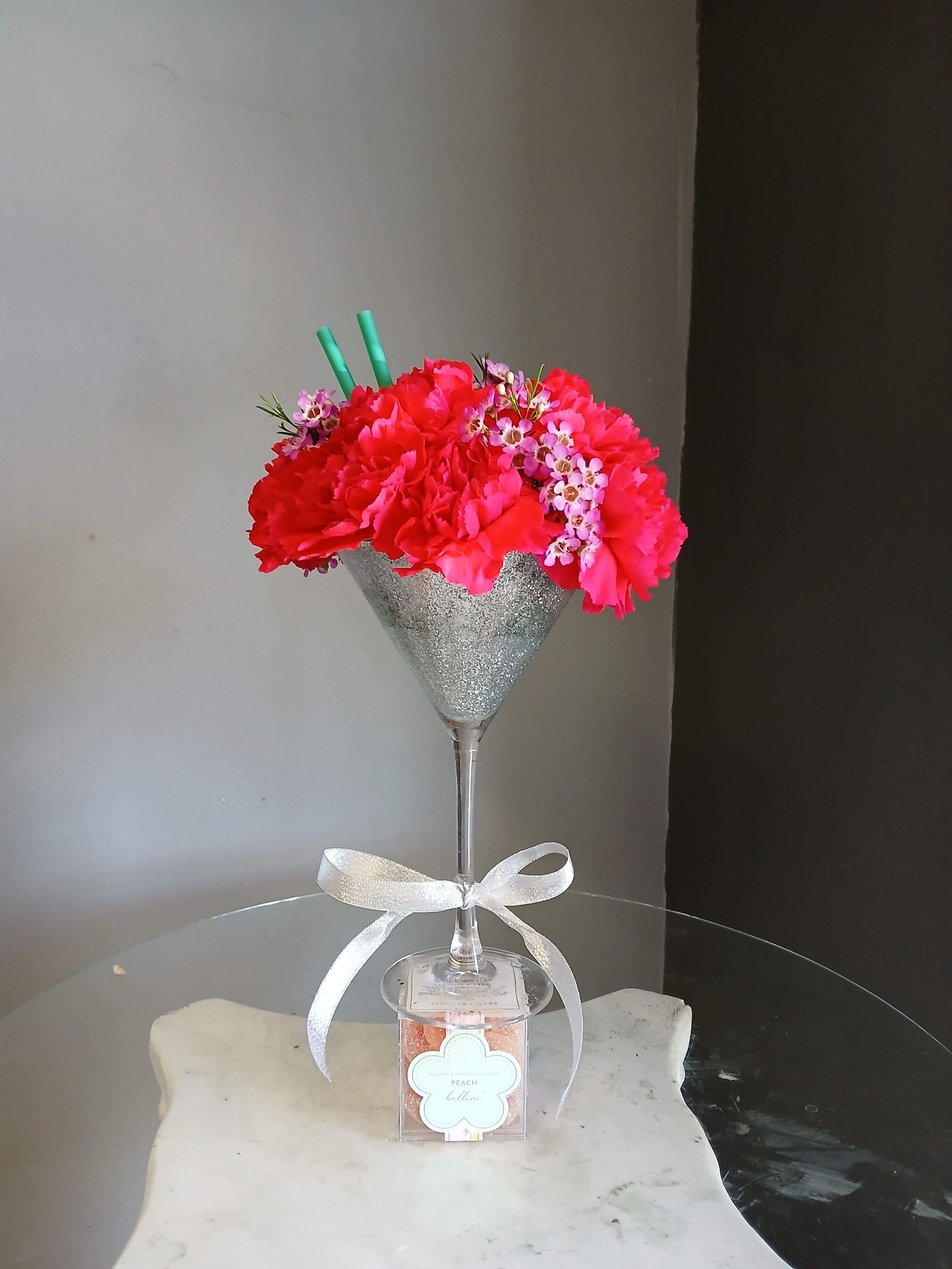 Carnation Cocktail - Vibrant Pink carnations in a dazzling martini glass paired with peach bellini gummies