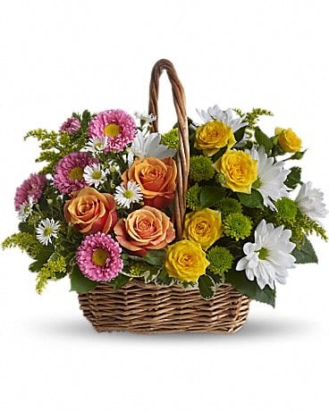 Sweet Tranquility Basket - A basket full of bright blossoms will deliver the warmth of sunshine even when the skies seem gray. This beautiful gift will be appreciated for its life-affirming brilliance and your thoughtfulness at this time. Brilliant blooms such as orange and yellow roses and spray roses mix with pink matsumoto asters, white daisy spray chrysanthemums, dazzling green button spray chrysanthemums, salal, pittosporum and more in a lovely rectangular basket with a handle. 