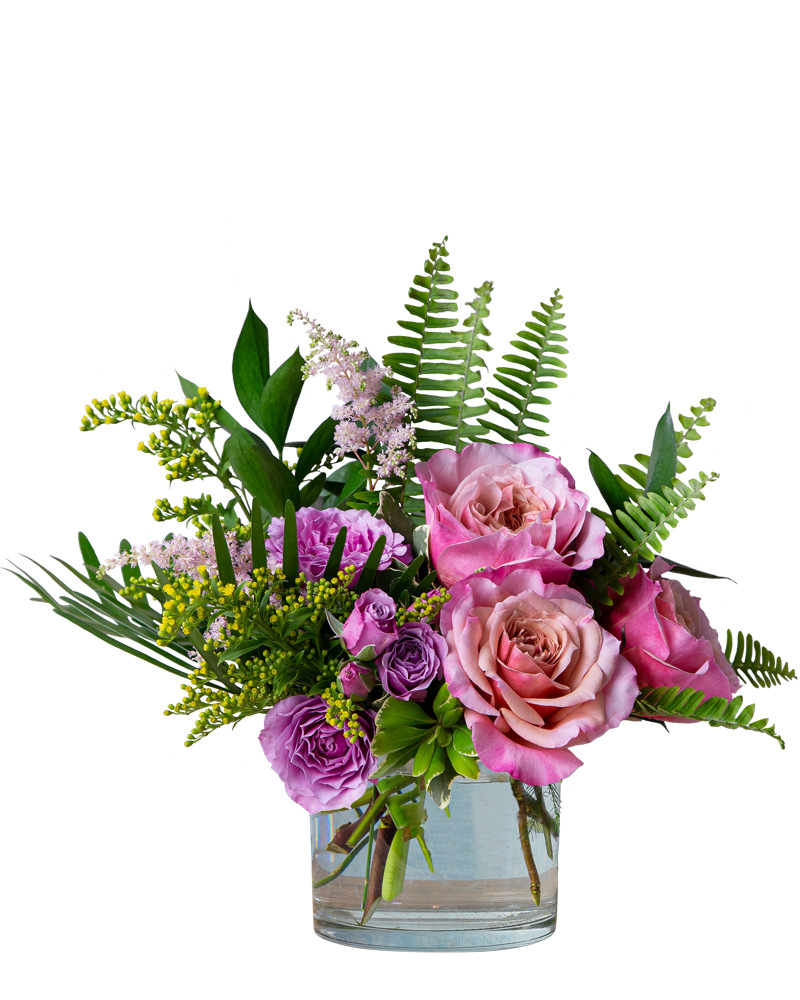 Blooming Spring - A beautiful arrangement in shades of pinks, lavender and yellow featuring blooms like garden roses, spray roses and solidago with lush foliage.