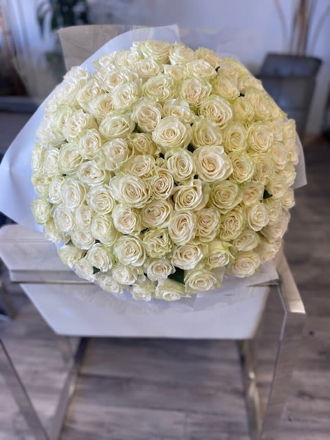  200 White Rose Bouquet  - An impressive grand bouquet of 200 premium fresh-cut white roses, carefully arranged to create a full, luxurious display. The abundant blooms come together in a clean, elegant design that makes a powerful and unforgettable statement. Finished with a matching satin bow for a refined touch.  Wrapping Upgrade: Add premium wrapping paper for +$10 to elevate the overall presentation.    Some florals are seasonal, if a particular flower will not be available due to season, we will substitute for similar flower, composition, color pallet and value of the arrangements as closely as possible. All effort to create a floral arrangement as close to the photo shown, the actual arrangement may vary slightly in its appearance from the photo shown. If you have any questions about your order, we welcome you to call us in or email    Holiday Delivery:  Same-day delivery available. Deliveries are made throughout the day based on routing.  