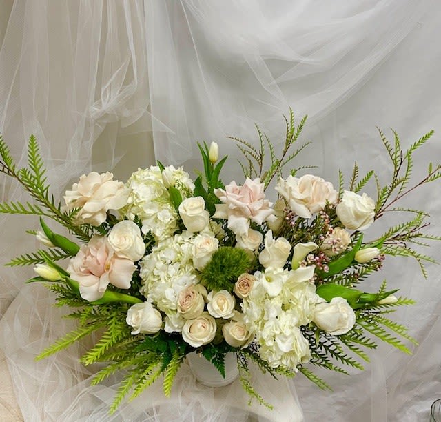 Blooming Marvelous  - Theme Colors: Shades of white and pink  Featured Blooms: Roses, Hydrangeas, Tulips and greens  HK Flowers have a uniqueness of florals and seasonal blooms, certain flowers or colors may not be available as each season affects the availability, color, size, and shape of each floral bloom. Some flowers may be substituted accordingly.  Photos are used as a reference for the color palette and is NOT indicated of the final product. We ask for your trust in us that we will pick out the best seasonal available blooms, while still capturing the arrangements theme and colors mentioned above.