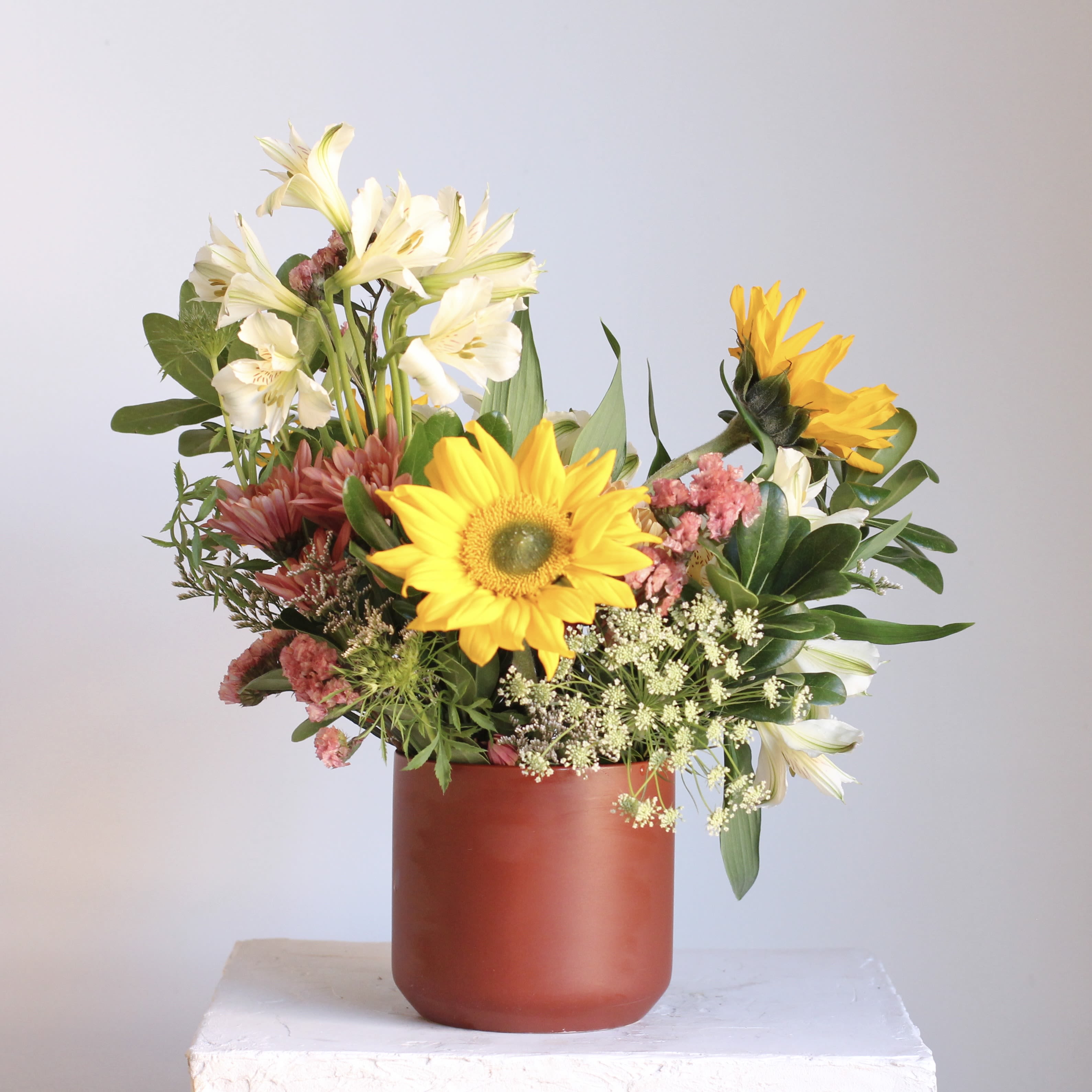 Sweet &amp; Sunny - Earthy yet refined, our "Sweet and Sunny" floral arrangement for a radiant burst of joy that's guaranteed to brighten anyone's day! This delightful arrangement is available in two sizes, with our standard option offering a charming, petite display that's both beautiful and budget friendly. Featuring cheerful sunflowers, it's like receiving a warm, sunny hug in floral form.  Delivery Policy: At Middlemist, we aim to make every delivery seamless and delightful. It is the sender’s responsibility to ensure the recipient is available to accept delivery between 3–5pm on the scheduled date and that the delivery address is accurate. We will send a text notification to the recipient on the day of delivery. If no one is available to receive the order, it will be returned to the shop and may be picked up or redelivered for an additional delivery fee. If a recipient requests the order be left unattended, we cannot guarantee the condition of the flowers or plants, and no refunds will be issued once an order is left outside.