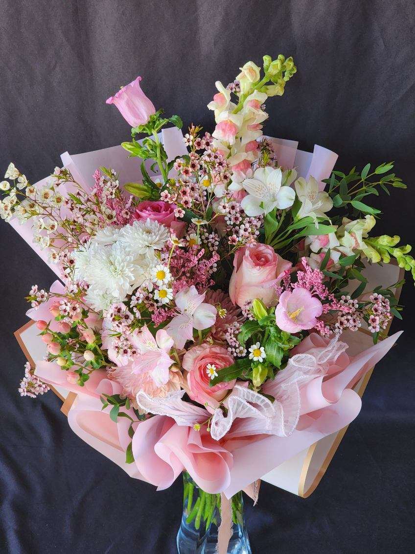 La Vie en Rose - Feminine, Romantic and Pure bliss! The bouquet is wrapped in pink ruffled wrapping yarn and paper but can be placed in a vase at your request, please call or specify in the special instructions. Premium will include Garden roses and seasonal flowers.