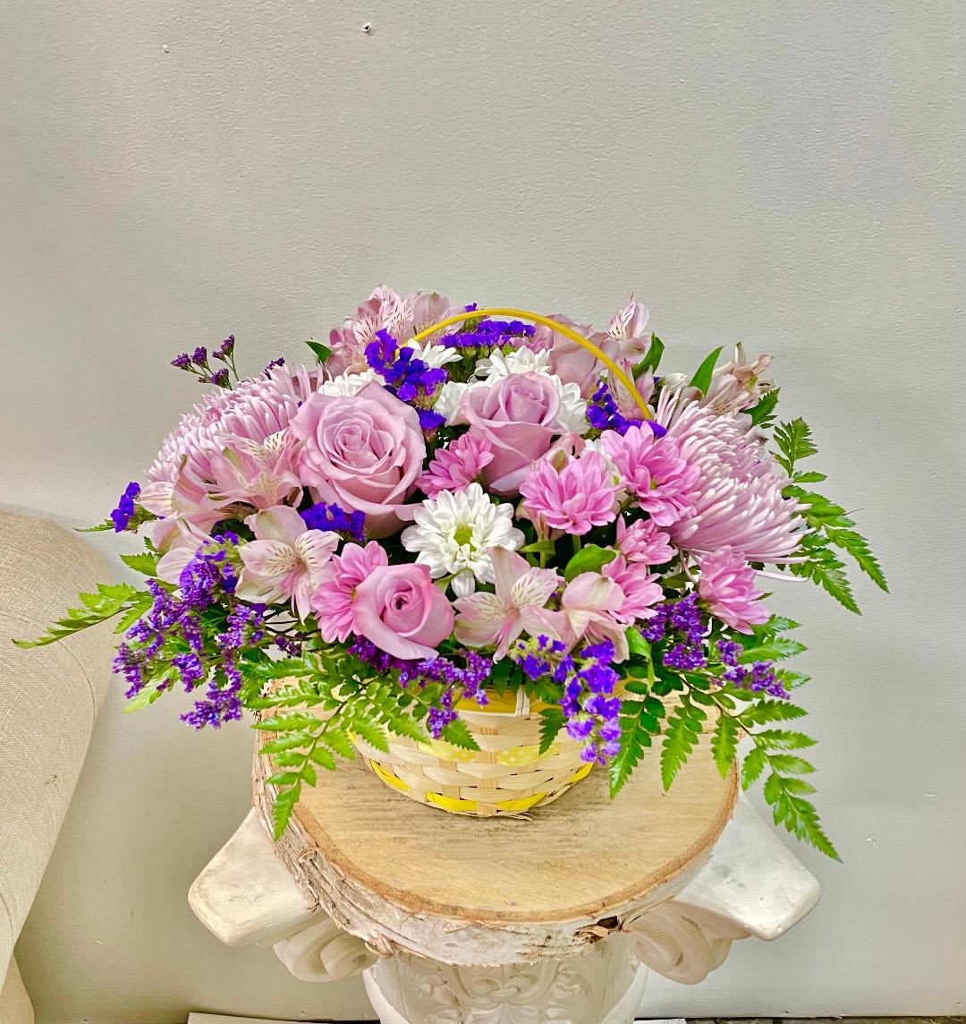 Mauve basket - Product Information  Theme Colors: Shades of pinks  Featured Blooms: Roses, Alstroemeria, Chrysanthemums, Daisies, wild greenery, Seasonal Blooms in the yellow Basket.  HK Flowers have a uniqueness of florals and seasonal blooms, certain flowers or colors may not be available as each season affects the availability, color, size, and shape of each floral bloom. Some flowers may be substituted accordingly.  Photos are used as a reference for the color palette and is NOT indicated of the final product. We ask for your trust in us that we will pick out the best seasonal available blooms, while still capturing the arrangements' theme and colors mentioned above.