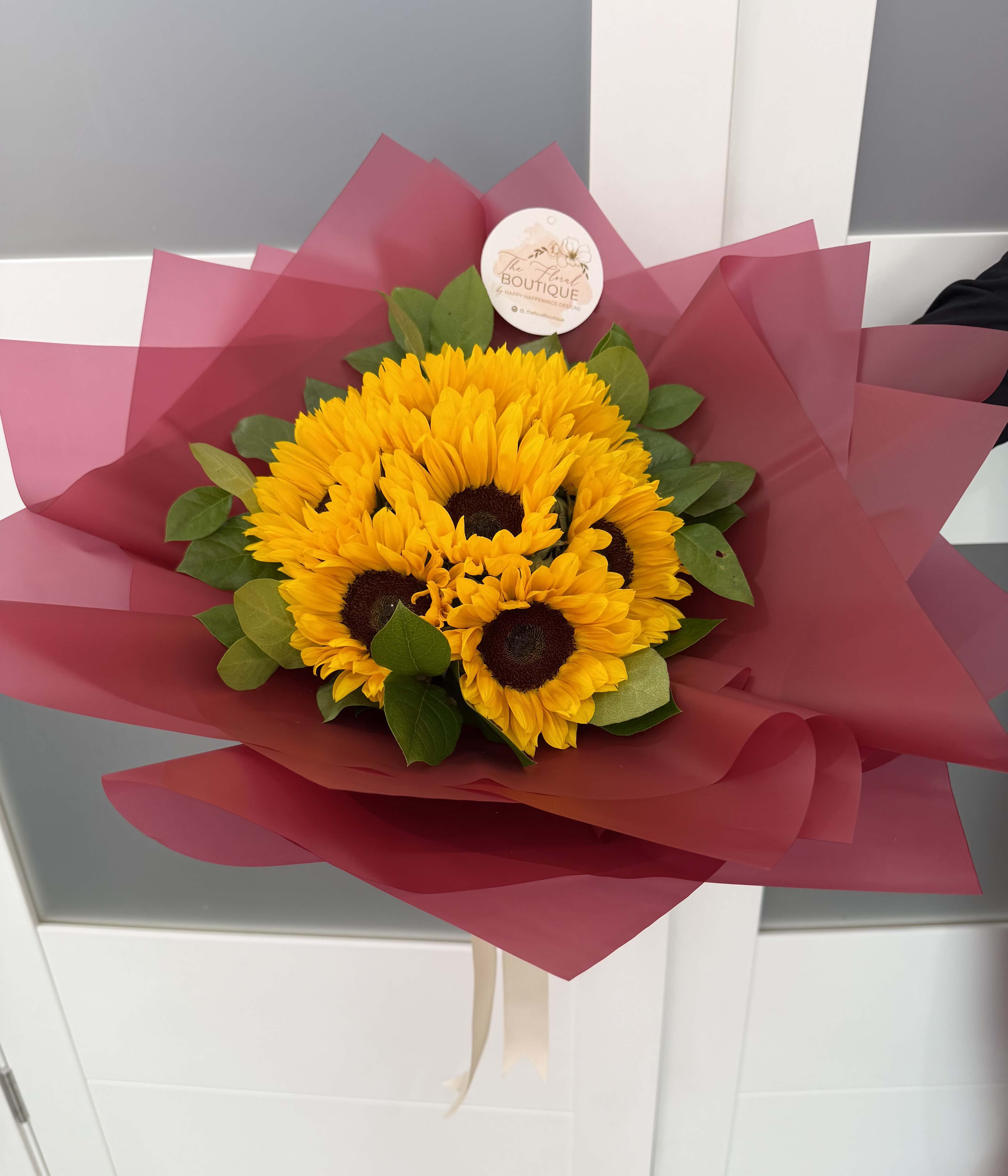 Sunflower Luxe Bouquet - Bright, cheerful, and full of sunshine. Our Sunflower Luxe Bouquet includes 12 large stems wrapped elegantly in our premium paper_is the perfect way to bring happiness!  Perfect for birthdays, thank-you, or just because --it's a timeless favorite that instantly lift the mood.