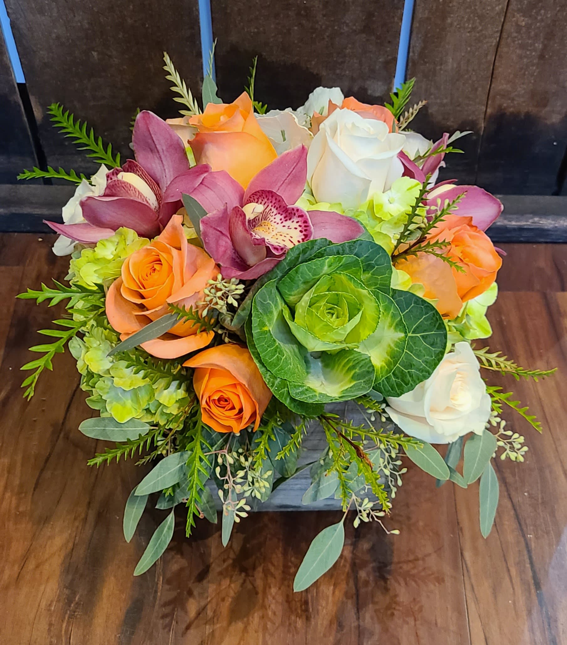 Cali cool - This arrangement is a 360 design, arranged in a wooden box. Subtle enough for any occasion, but cheerful and vibrant like the Cali sun.