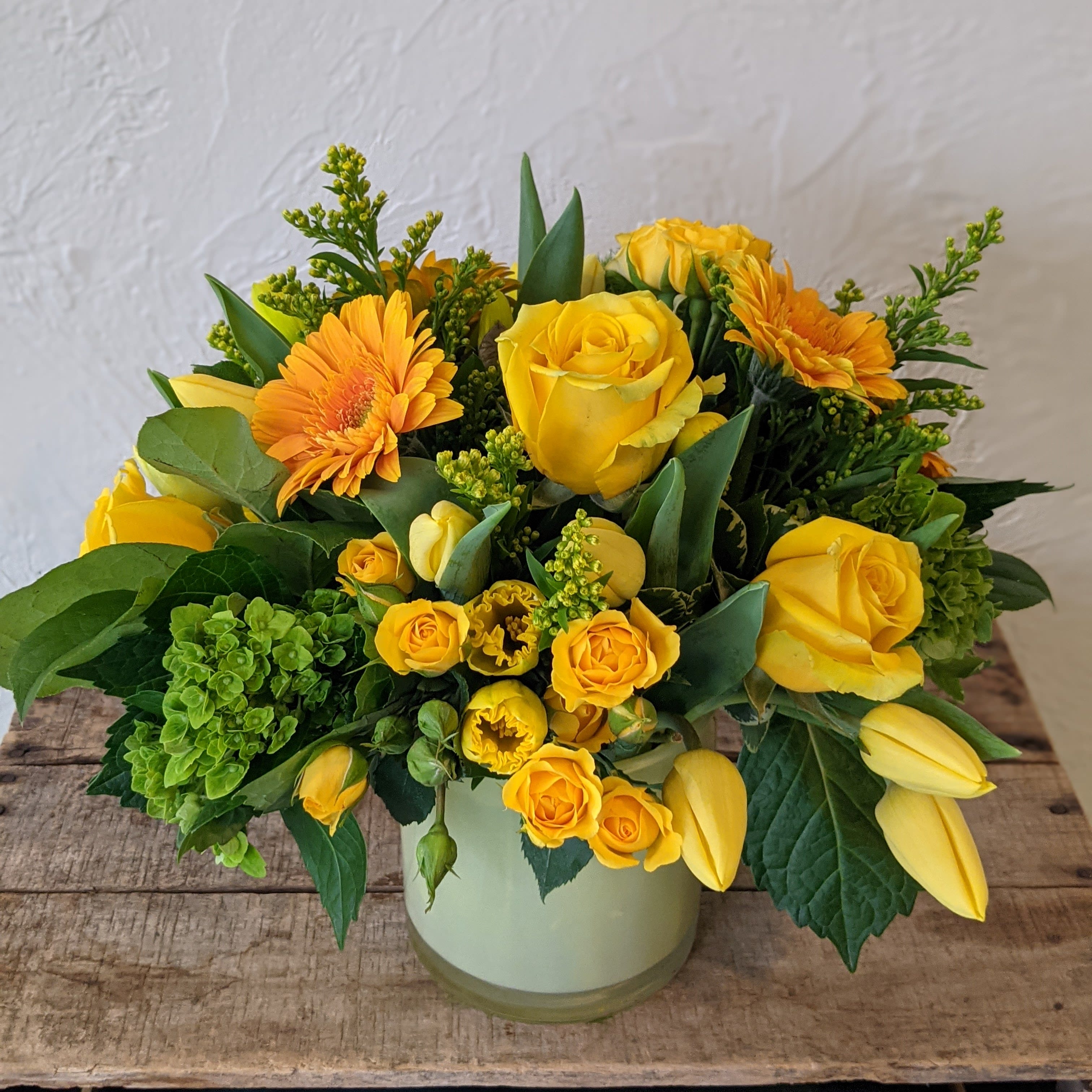 Monochrome Designer's Choice - Yellow  - Pick the color and leave the flowers up to us with our Monochrome series Designer's Choice flower arrangements. These pieces feature a primary color pallet which we will design a beautiful arrangement of flowers around. Some accent colors may be used but the primary color scheme will designed with your chosen color in mind (Color listed in the name of this piece)    *Vase color and style may vary. Please note that the arrangement displayed in the picture is an example piece and flowers featured are not guaranteed to be replicated