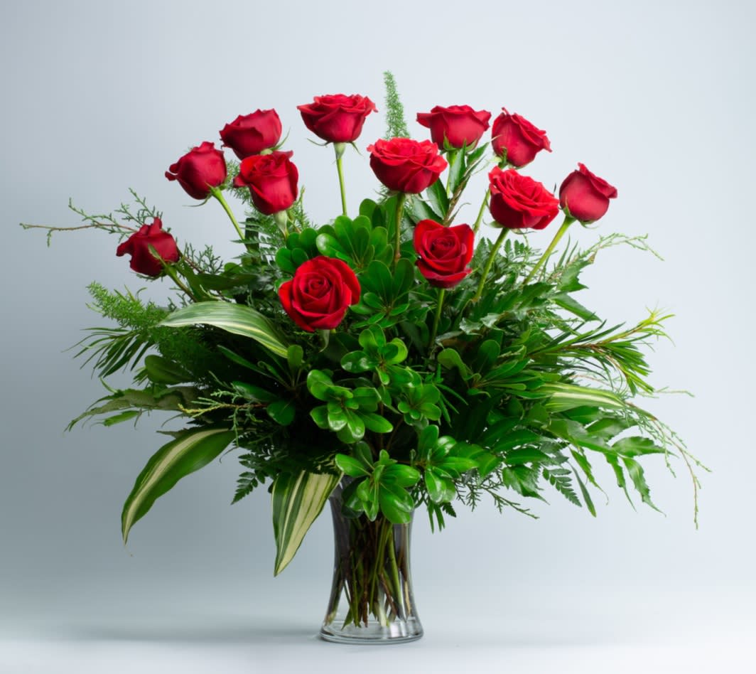 The OG. 12 or 24 roses*  A Floral Archist™ design.  - The Original Gallant (OG)! A hot dozen (or two) in its traditional mood of red. Traditional? Perhaps! But with a touch of exotic. Why not? Love never goes out of style! 12 or 24 roses design.   PJf reminds you that guys love flowers too! Male appropriate.  NOTE: Our flowers and greens are a gift from nature. It’s shade and depth might vary, design, aesthetic and value, remains the same. In support of our efforts to aide in the preservation of our planet, PJf uses Fair Trade flowers, Upcycled and Recycled containers.  Seasonal Detail:  We add herbs to some designs to enhance the medley of scents. Herbs addition is seasonal and only if scents are comparable with flowers to be used. (Peppermint, Lemon Grass, Rosemary or Basil).