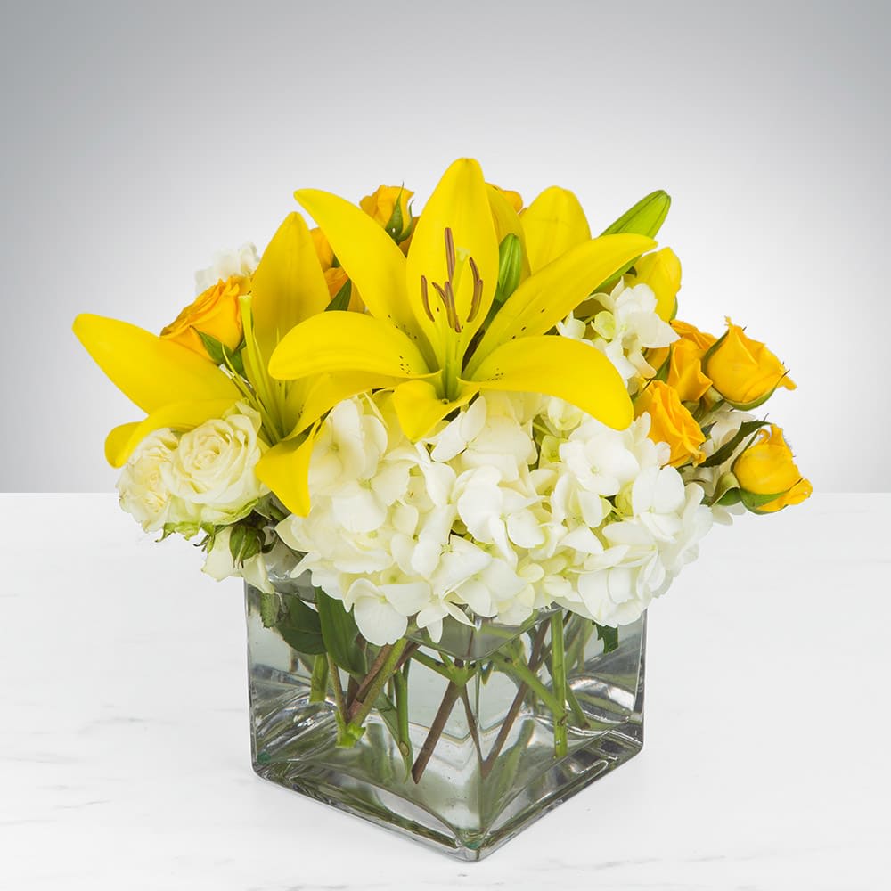 Kiss of the Sun - Bring the sunshine to someone's day with the gorgeous, fragrant bouquet. This arrangement contains asiatic lilies, spray roses, and hydrangea. It is the perfect gift for someone's birthday or to uplift someone's spirits. APPROXIMATE DIMENSIONS: 9"L X 9"W x 9"H