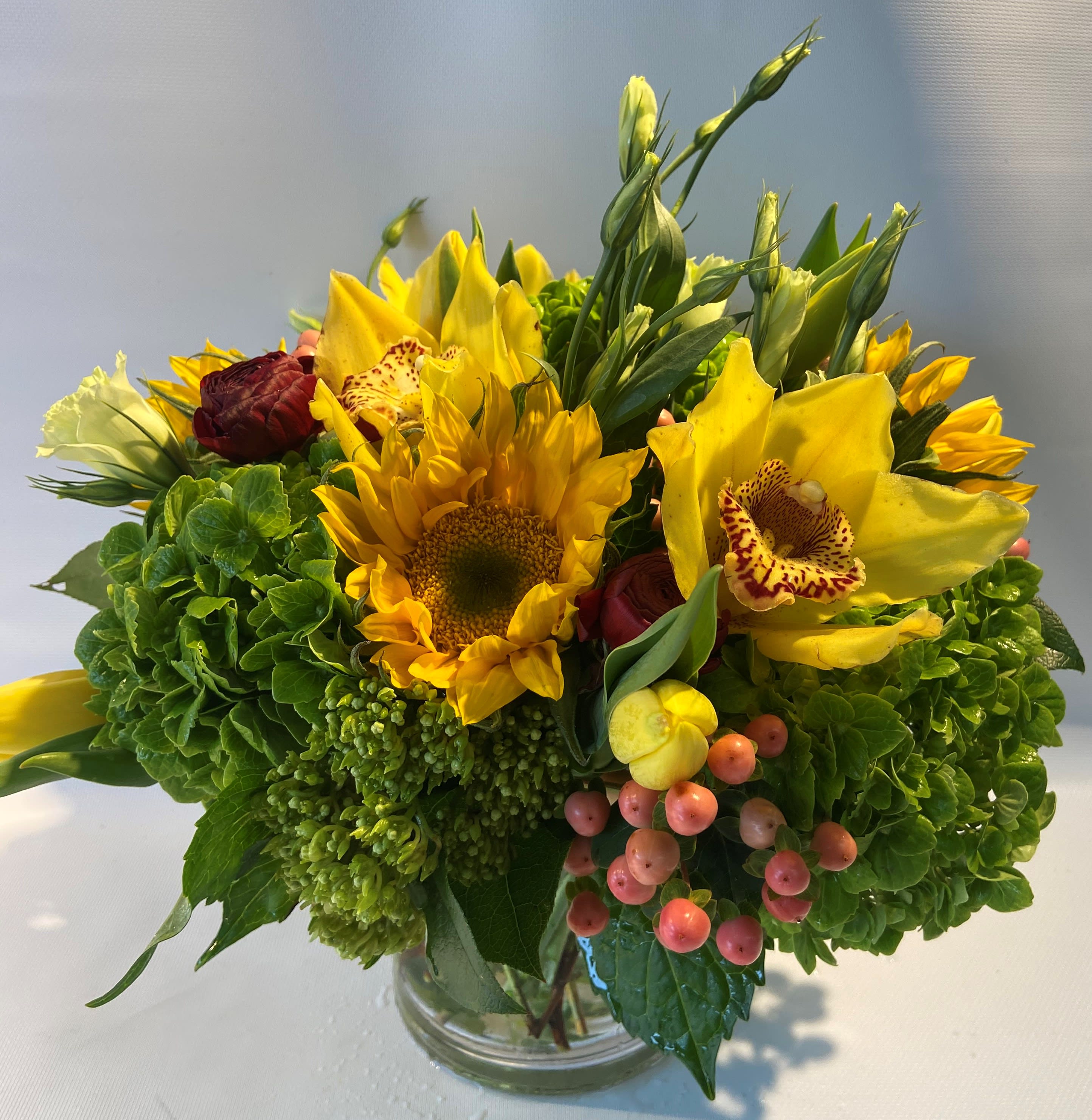 Sunny petals - This sunny and bright arrangement is our way of celebrating spring coming! Featured with sunflowers and beautiful hydrangea this is perfect for anytime occasion or just because! 