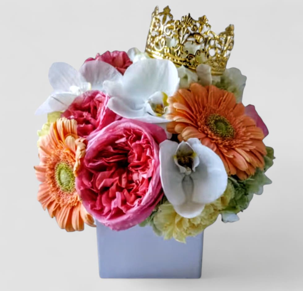 Blush Pink Beauty Bouquet Designer's Choice - Send this beauty today to show them that you are thinking of them with it's beautiful pink roses orchids and more arranged in a modern white glass vase adorned with a gold crown. Perfect to send for every occasion. All bouquets are always made extra special and unique each and every time. Please visit my beautiful gallery to see my latest designs that I have created for my online customers. Send them happiness today.