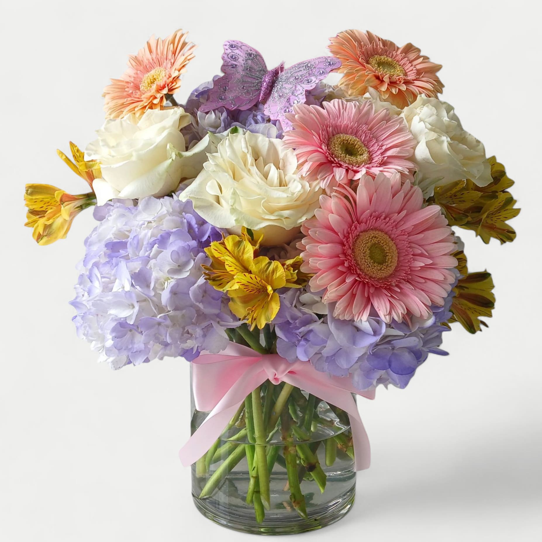 Bestie Bouquet Designer's Choice - Send this beautiful bouquet to your bestie today to make them smile with it's lovely mixed blossoms of that day roses orchids and more arranged in a tall modern glass cylinder style vase wrapped in citrus jute ribbon. Perfect as a Happy Birthday or any occasion to send happiness. Always made extra special and unique.