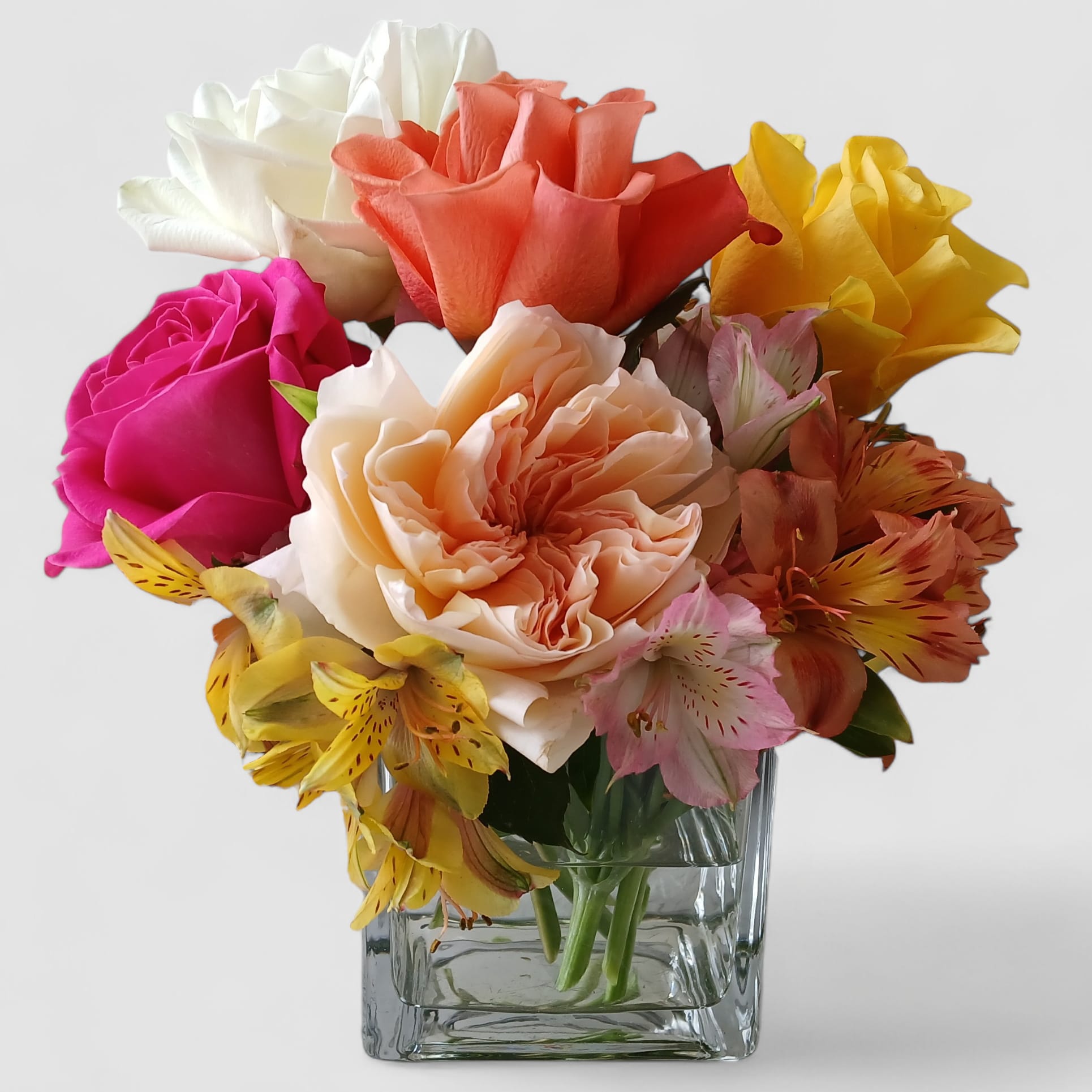 Colorful Rose Bouquet - Send this sweet gesture today to make them smile. Shades of pretty roses arranged in a modern glass vase. 