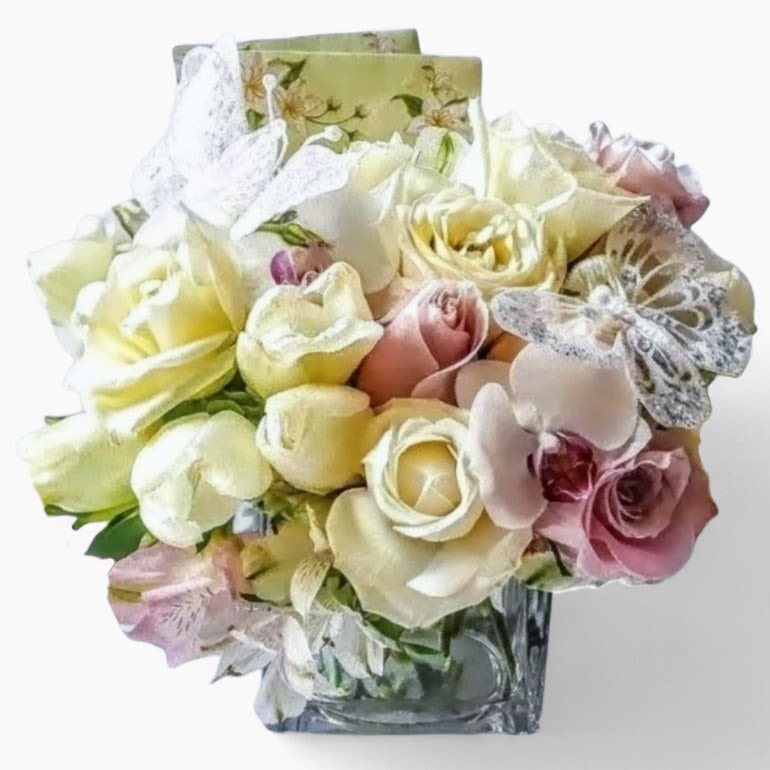Vanilla Blanca Bouquet Designer's Choice - This design is intended for home delivery only. Not for services. Designer's choice; made beautifully from my vanilla blossoms of the day roses orchids and more arranged in a modern glass cube style vase wrapped in vanilla jute ribbon. Beautiful and perfect to send today to show them how much you care. All bouquets are always made extra special and unique each and every time. Send them happiness.