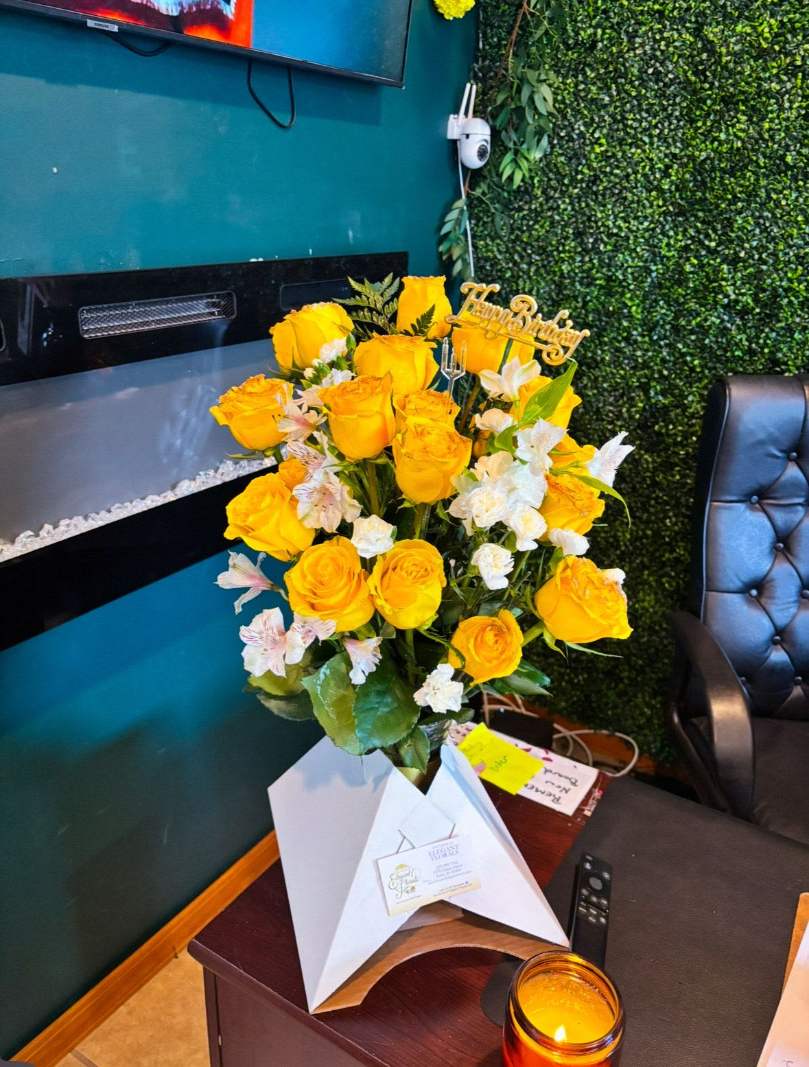 Golden Hour Vase Arrangement  -  A selection of elegant roses, lilies, with soft greens for contrast, arranged to showcase their beauty.  