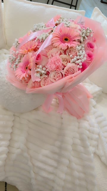 "Pink Serenity" Bouquet - A soft and elegant bouquet bursting with blush pink gerberas, roses, carnations, and delicate baby’s breath — wrapped in a dreamy pink veil and finished with satin ribbon. A perfect gift to express love, gratitude, or sweet affection.  48 roses  5 gerberas  Baby Breath Carnation